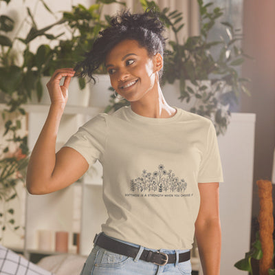 "Model wearing Savage Cotton's Softness is a Strength T-shirt – relaxed fit, soft cotton, bold red text across the chest"