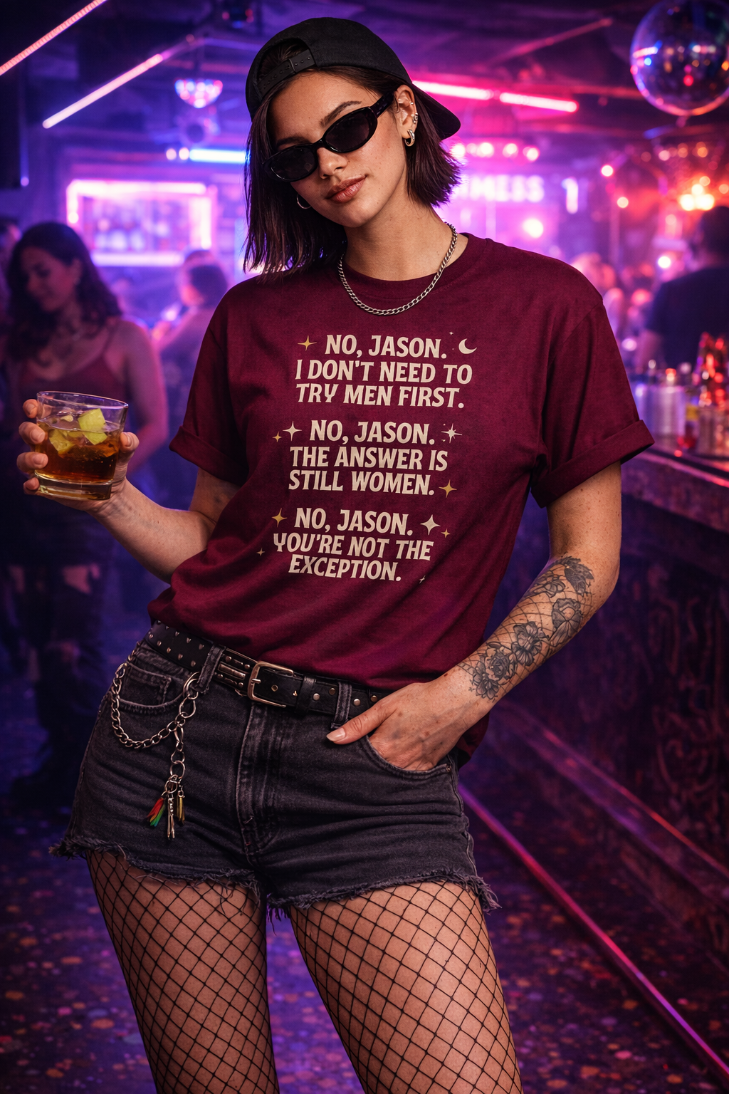 Person wearing a maroon t-shirt with text in a nightclub setting