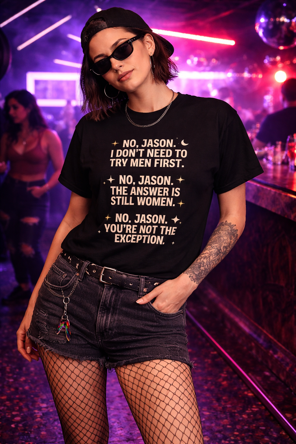 Person wearing a black t-shirt with text in a nightclub setting