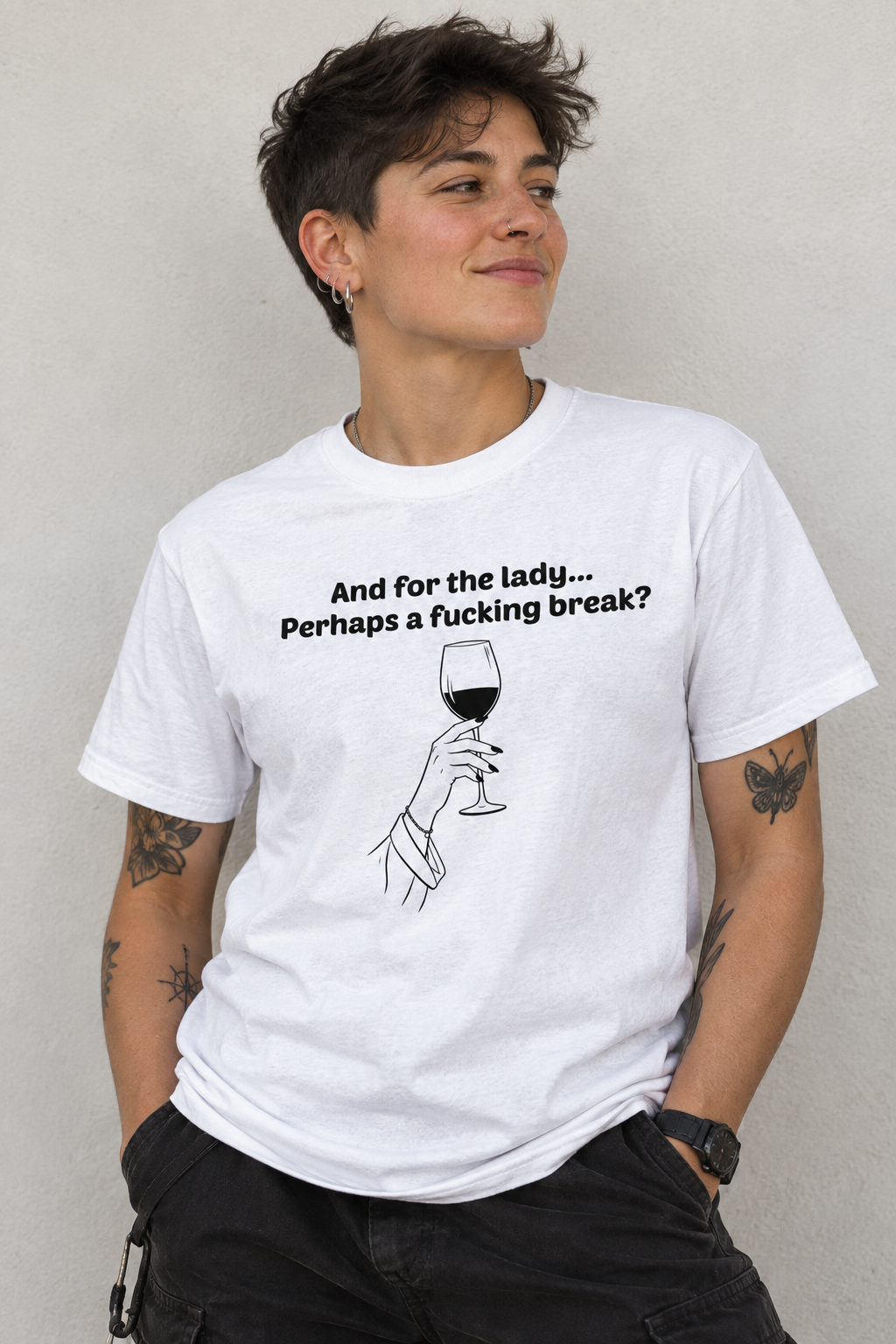 A person wearing a white graphic T-shirt with black text reading 'And for the lady.