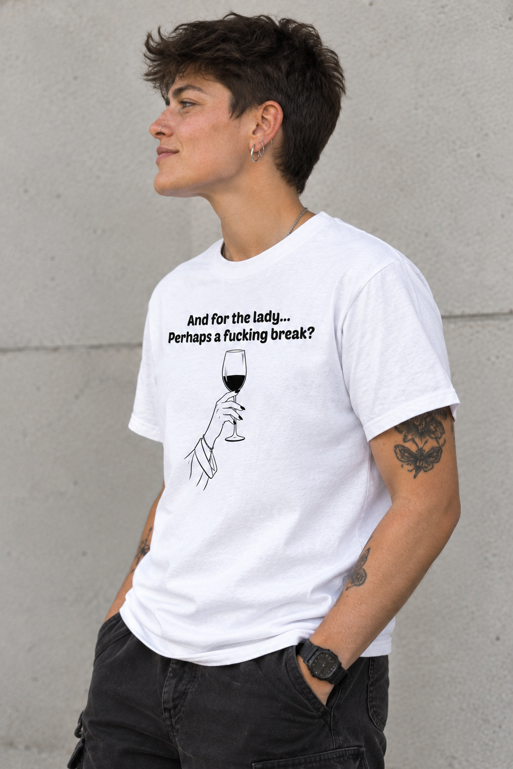 A person wearing a white graphic T-shirt with black text reading 'And for the lady.