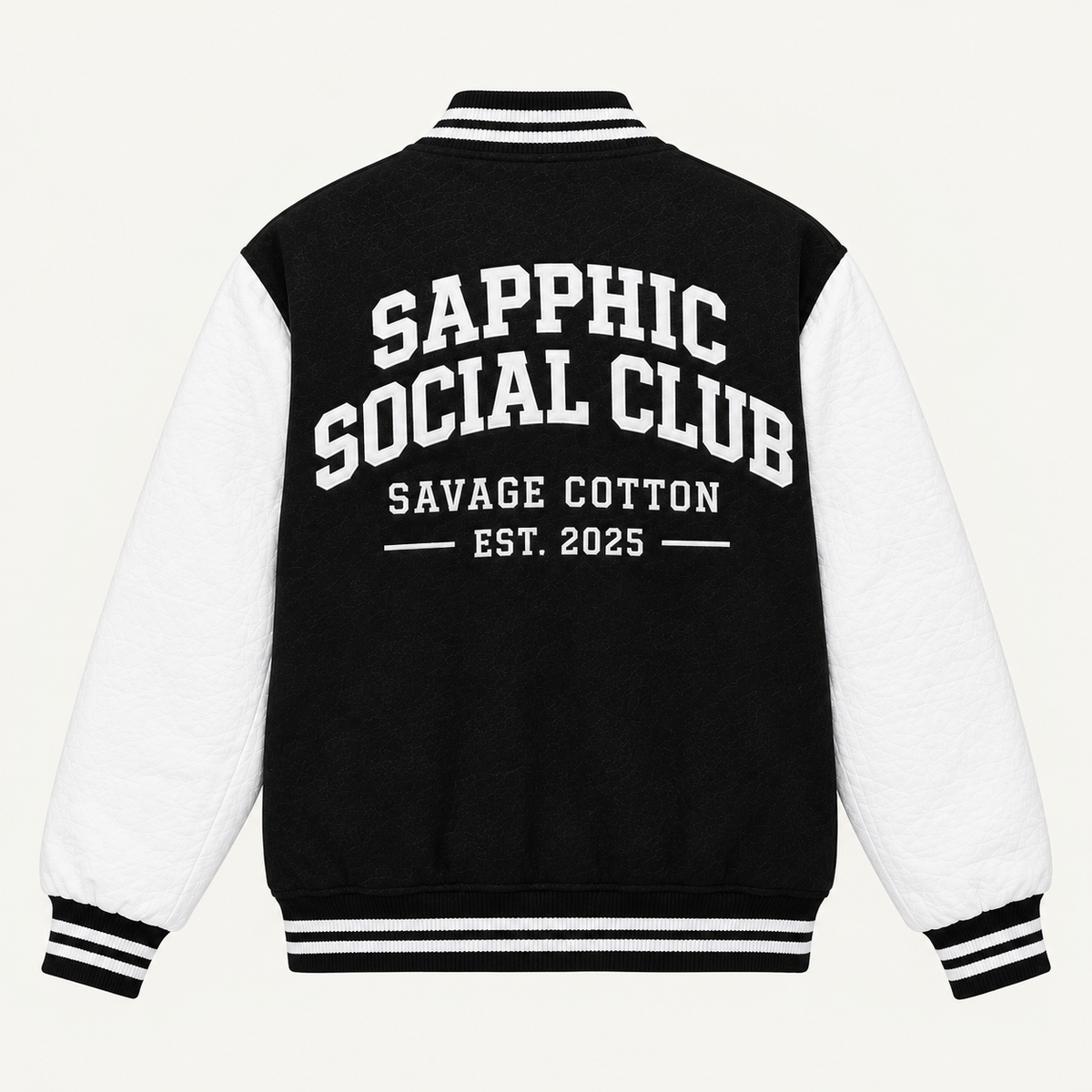 Back view of a varsity-style jacket with a black body and white sleeves, featuring the text 'SAPPHIC SOCIAL CLUB', 'SAVAGE COTTON', and 'EST. 2025' printed in white on the back.