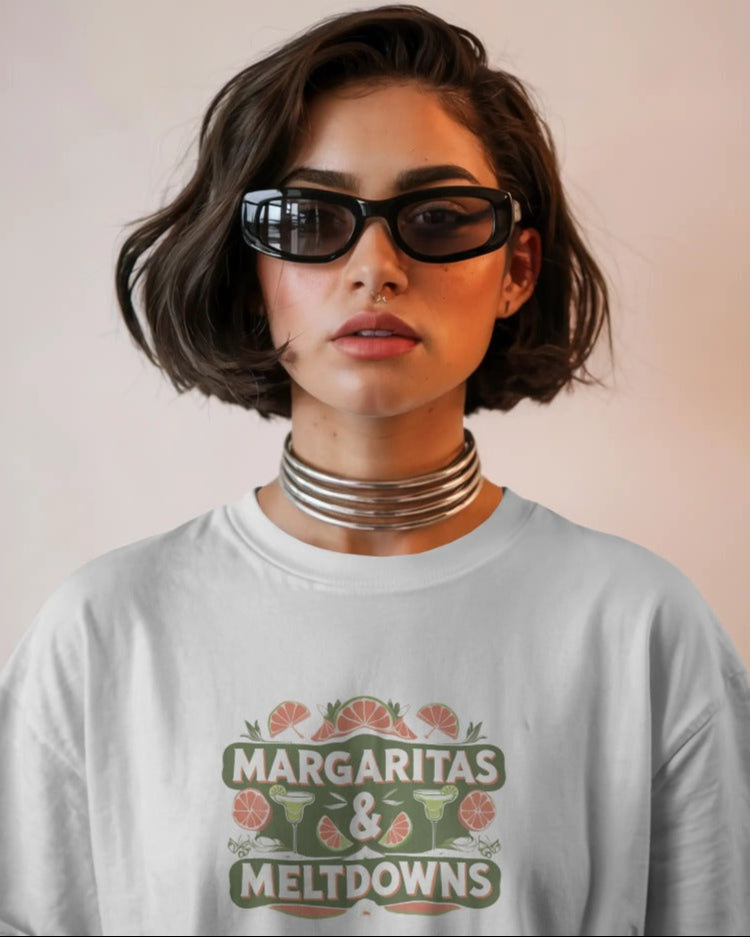 Model wearing Margaritas & Meltdowns slogan T-shirt by Savage Cotton in soft lime green, styled with sunglasses and bold lipstick for summer