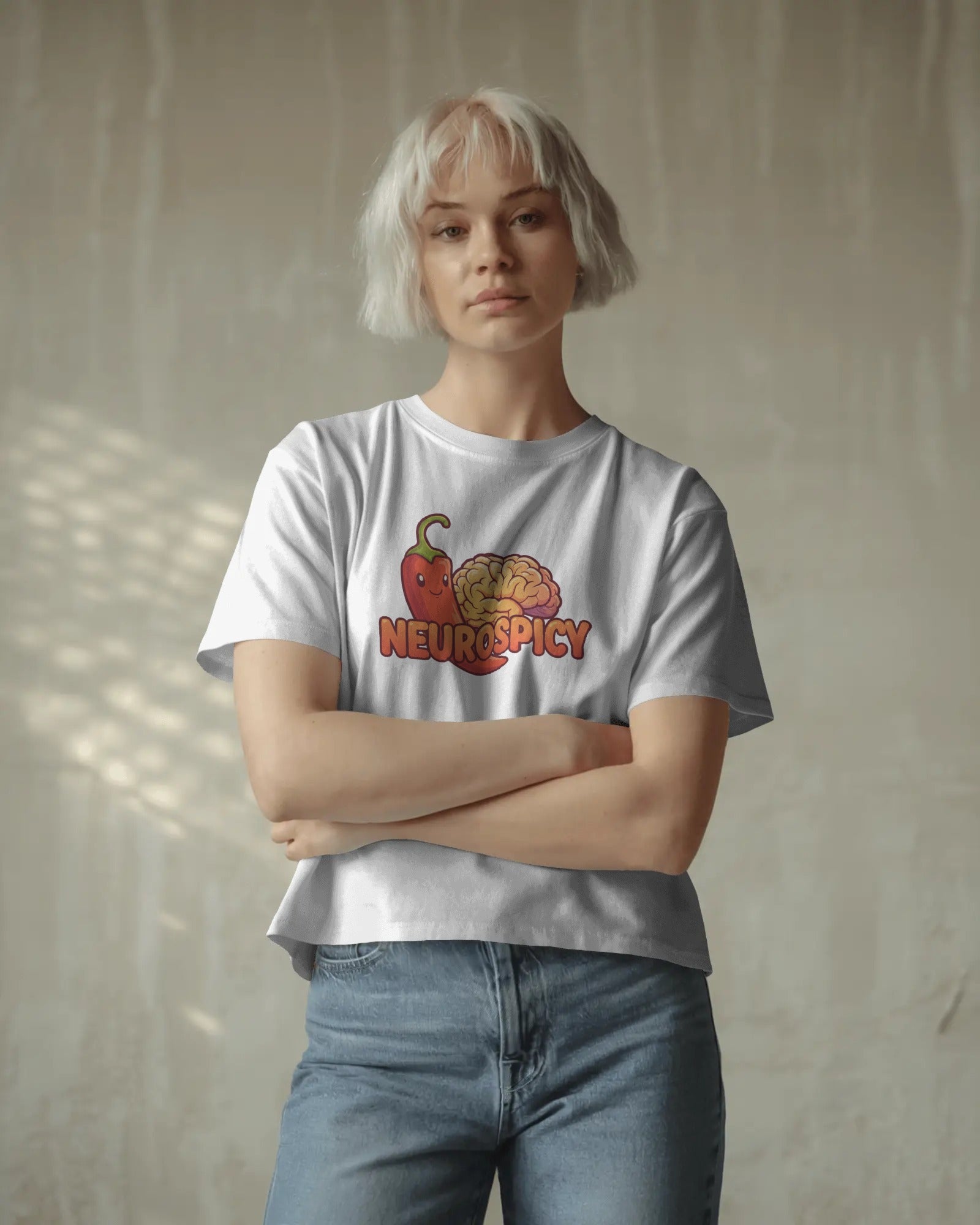 Neurospicy slogan t-shirt worn by a confident model, celebrating neurodivergence and mental health with bold, playful typography