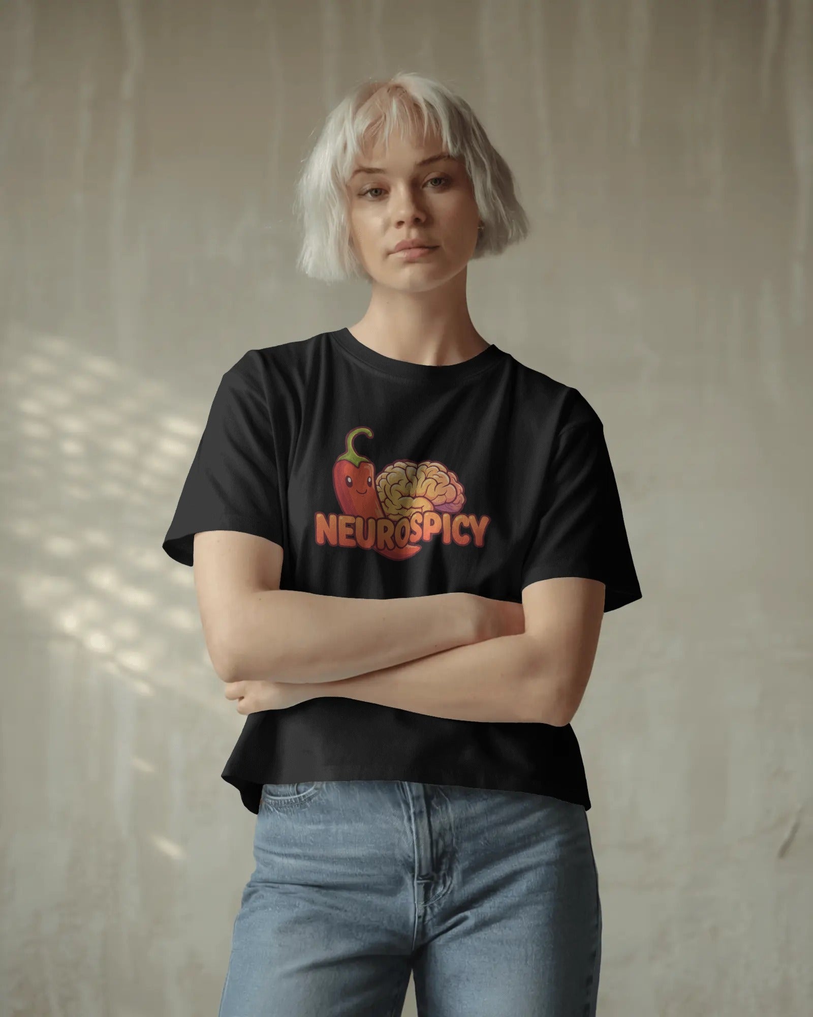 Neurospicy slogan t-shirt worn by a confident model, celebrating neurodivergence and mental health with bold, playful typography
