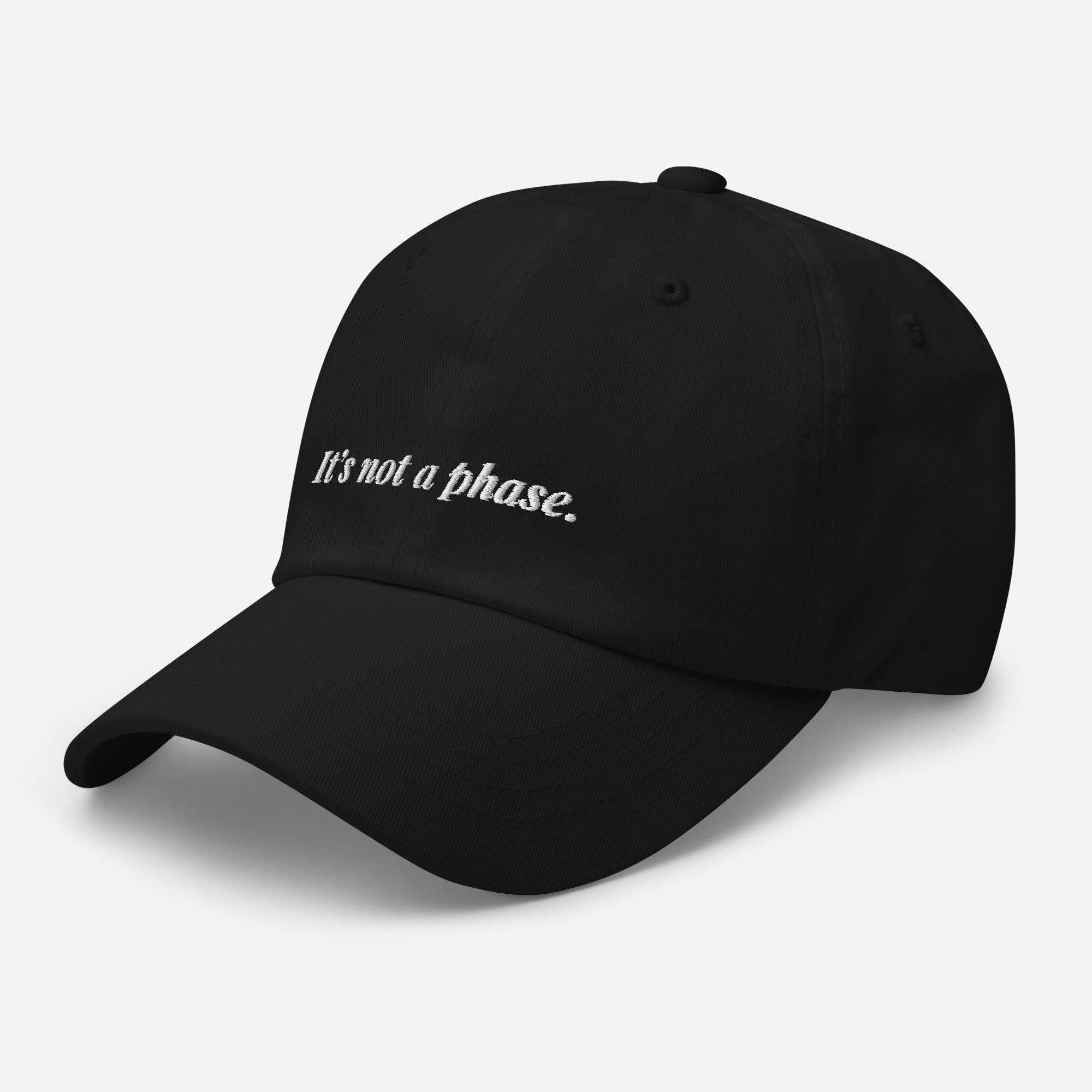 Black cap with 'It's not a phase.' text on a light gray background