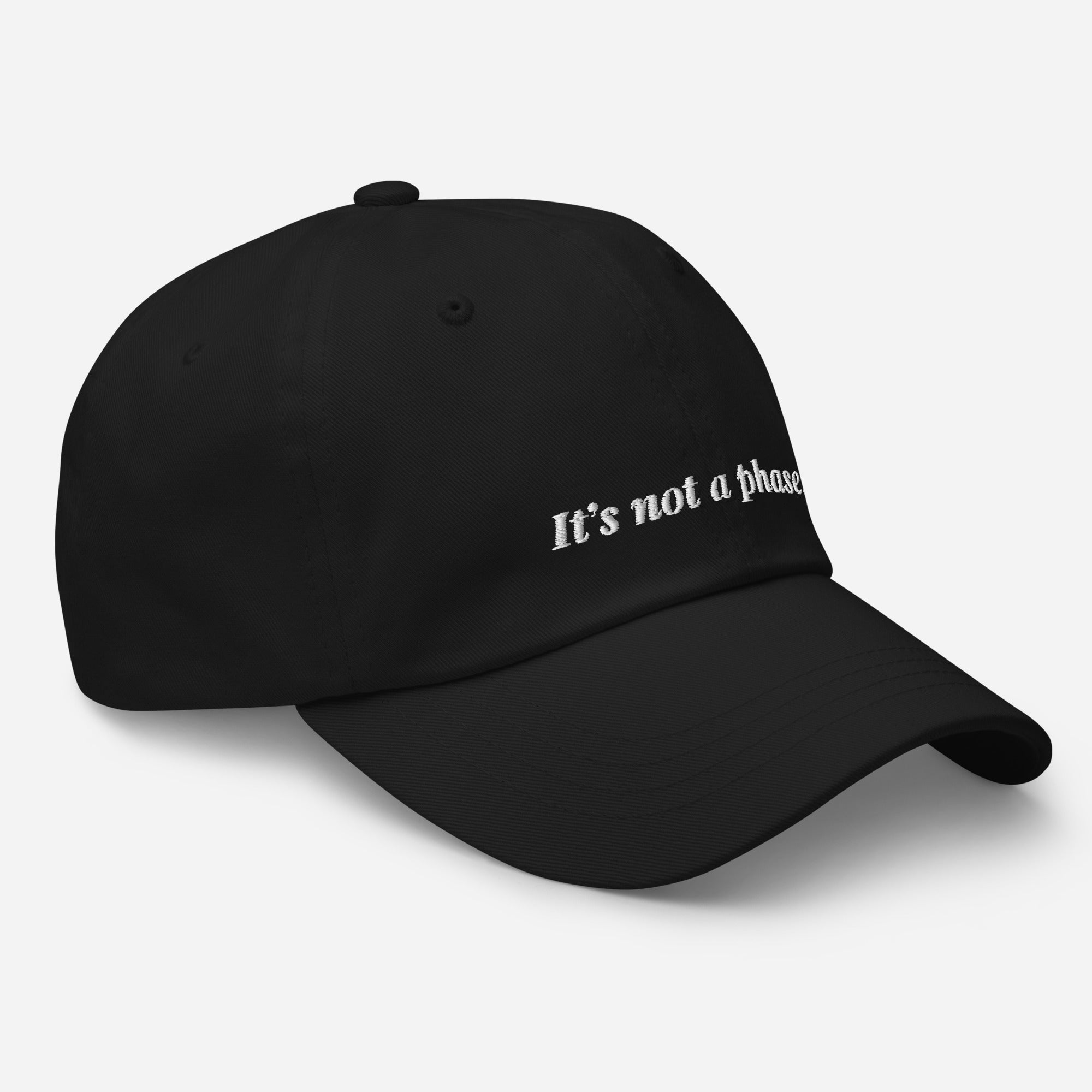 Black cap with 'It's not a phase' text on a light gray background