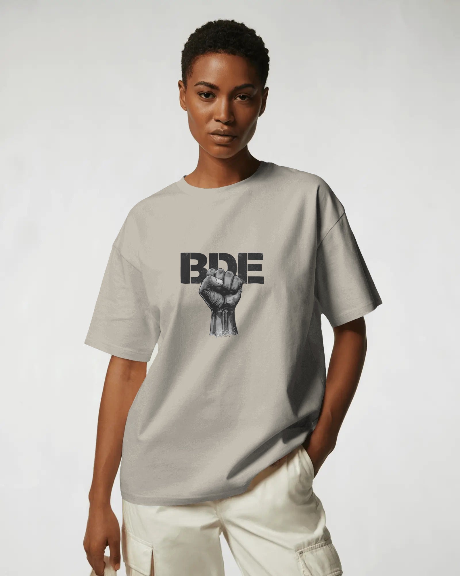 Masc lesbian wearing oversized BDE queer slogan t shirt