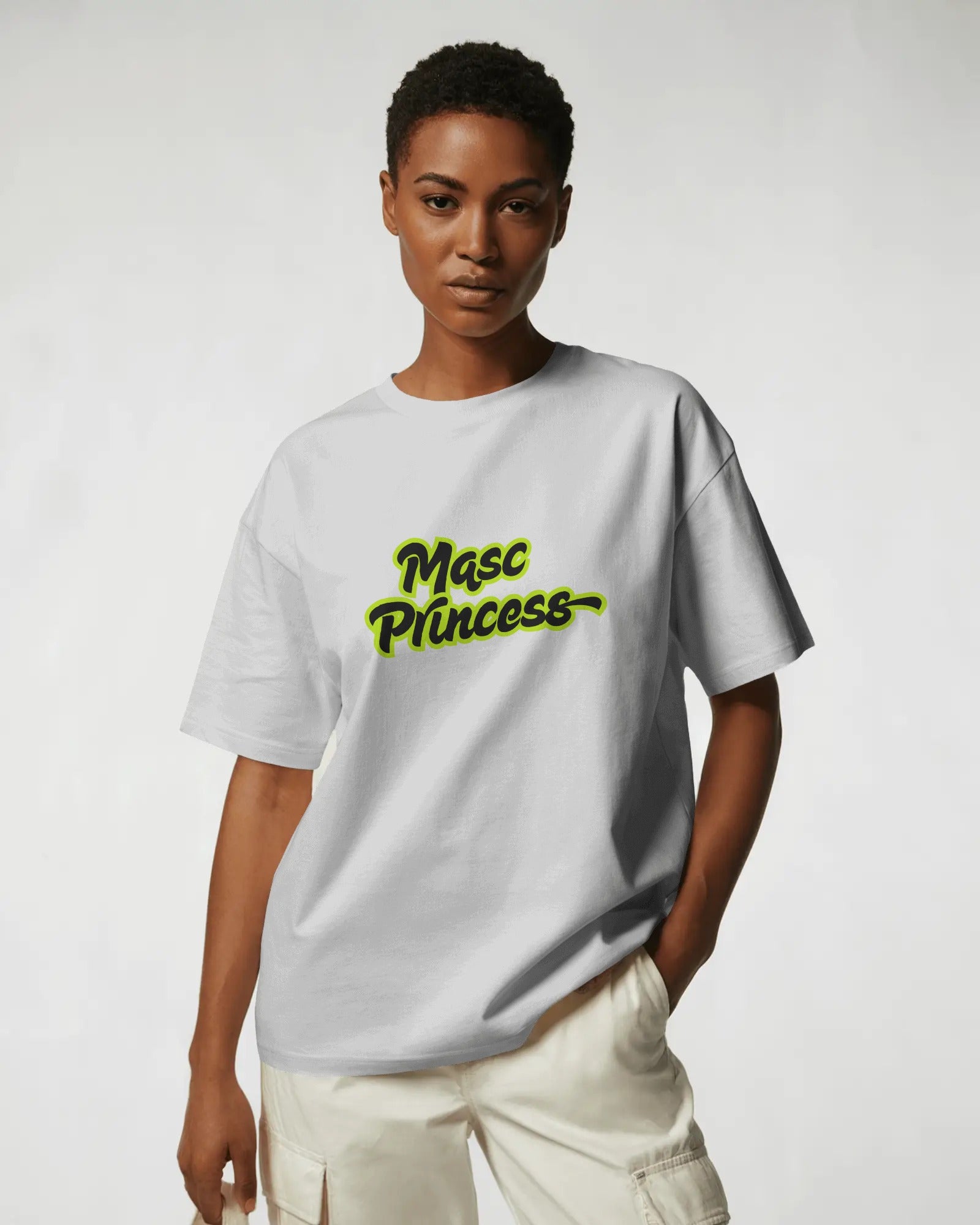 Female model wearing black Masc Princess oversized t-shirt with neon green slogan, styled with ripped jeans and sunglasses, queer streetwear fashion