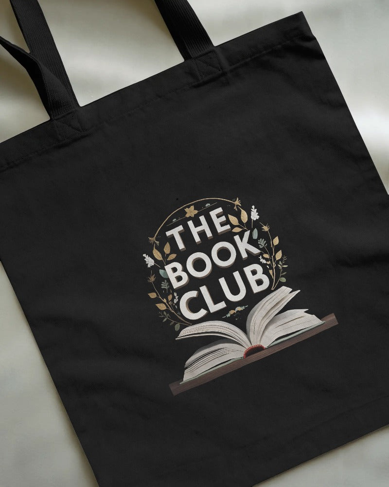 Black tote bag with 'The Book Club' design on a light background