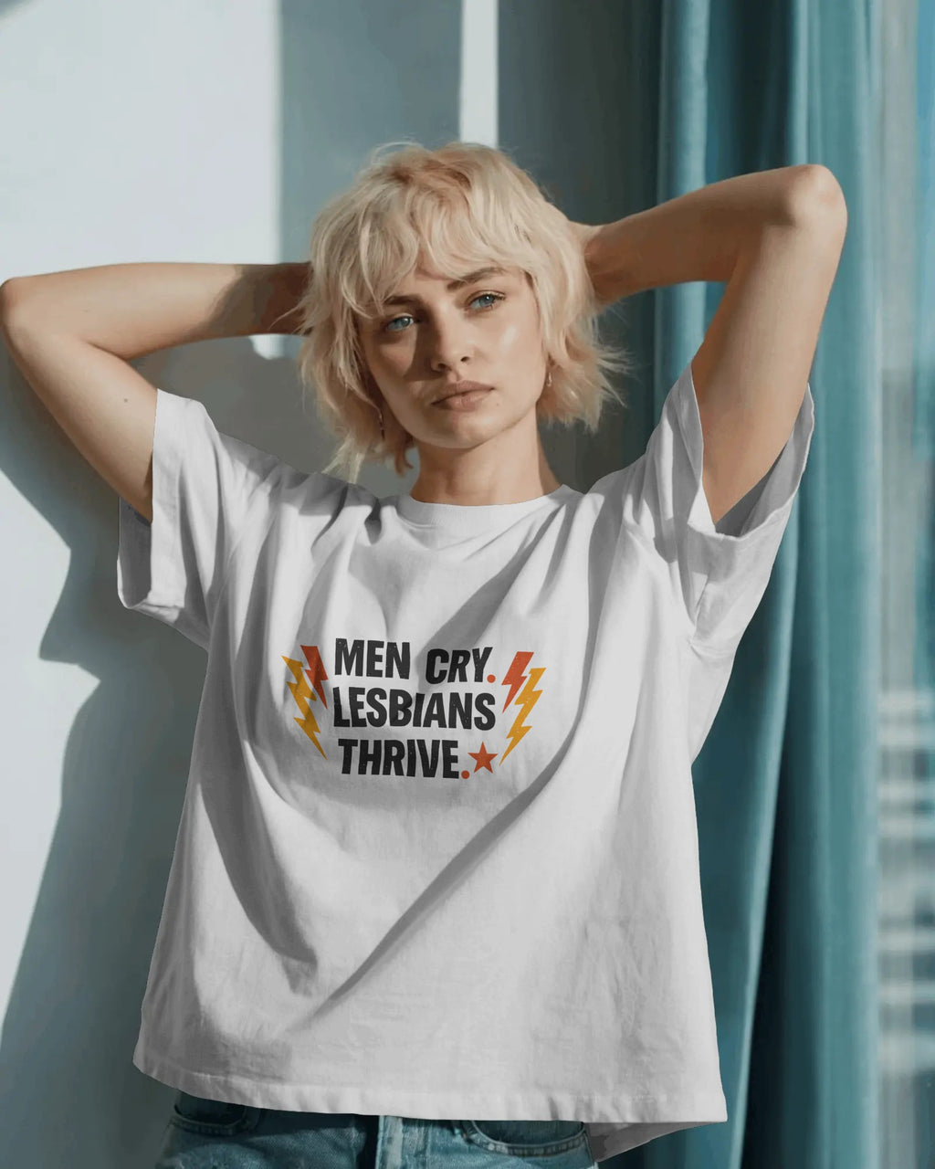 Men Cry, Lesbians Thrive slogan printed on a unisex t-shirt with bold typography on a neutral background