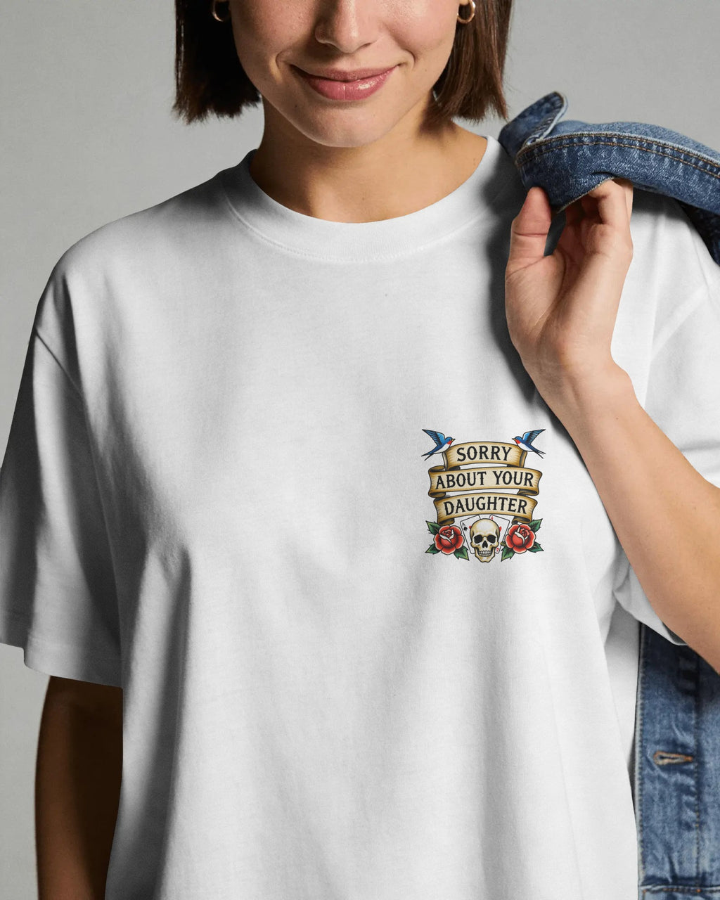 Person wearing a white t-shirt with a graphic design on a plain background