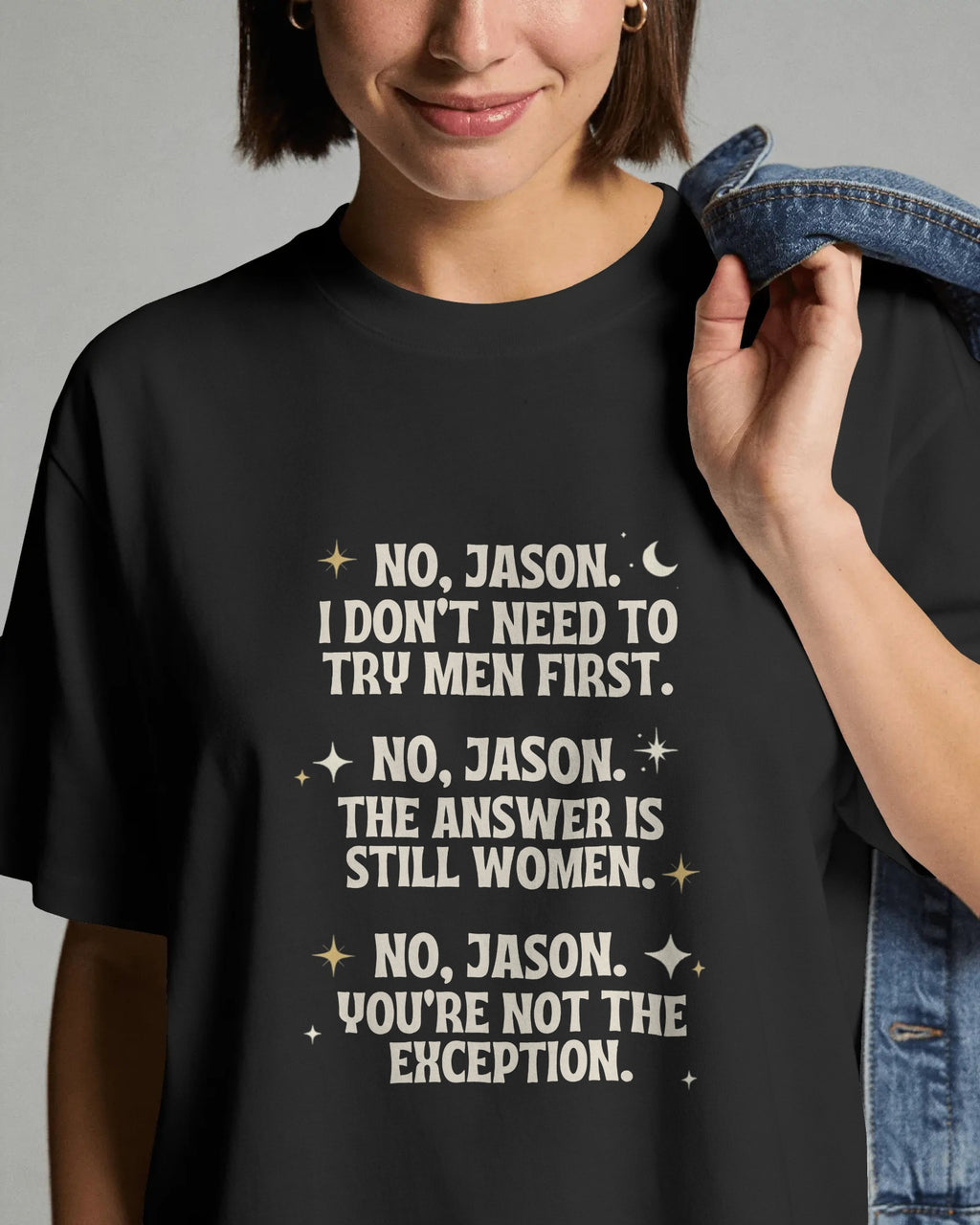 Person wearing a black t-shirt with white text on a gray background
