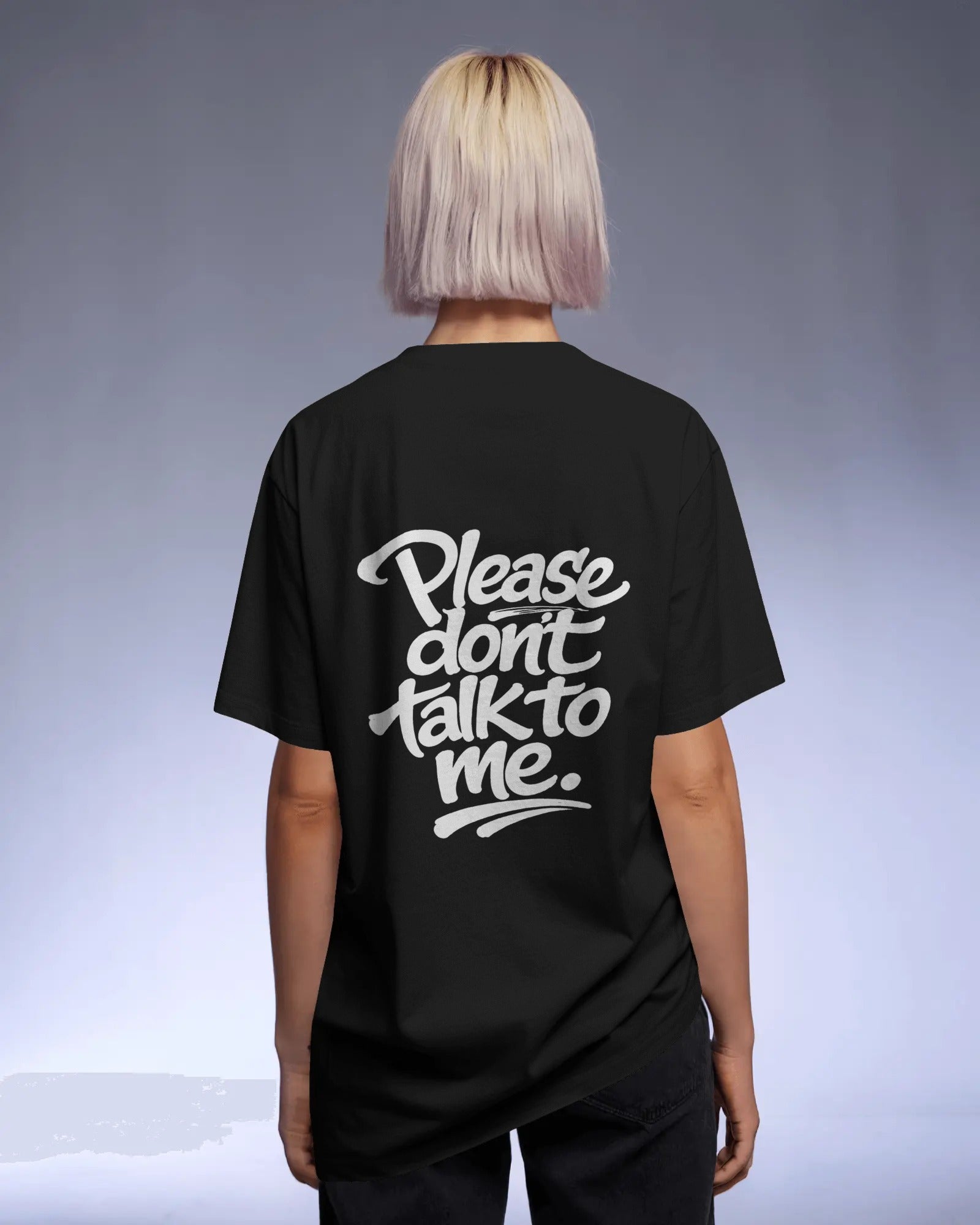 Model wearing a black oversized “Please Don’t Talk To Me” slogan t-shirt with relaxed fit and dropped shoulders, styled for everyday streetwear.
