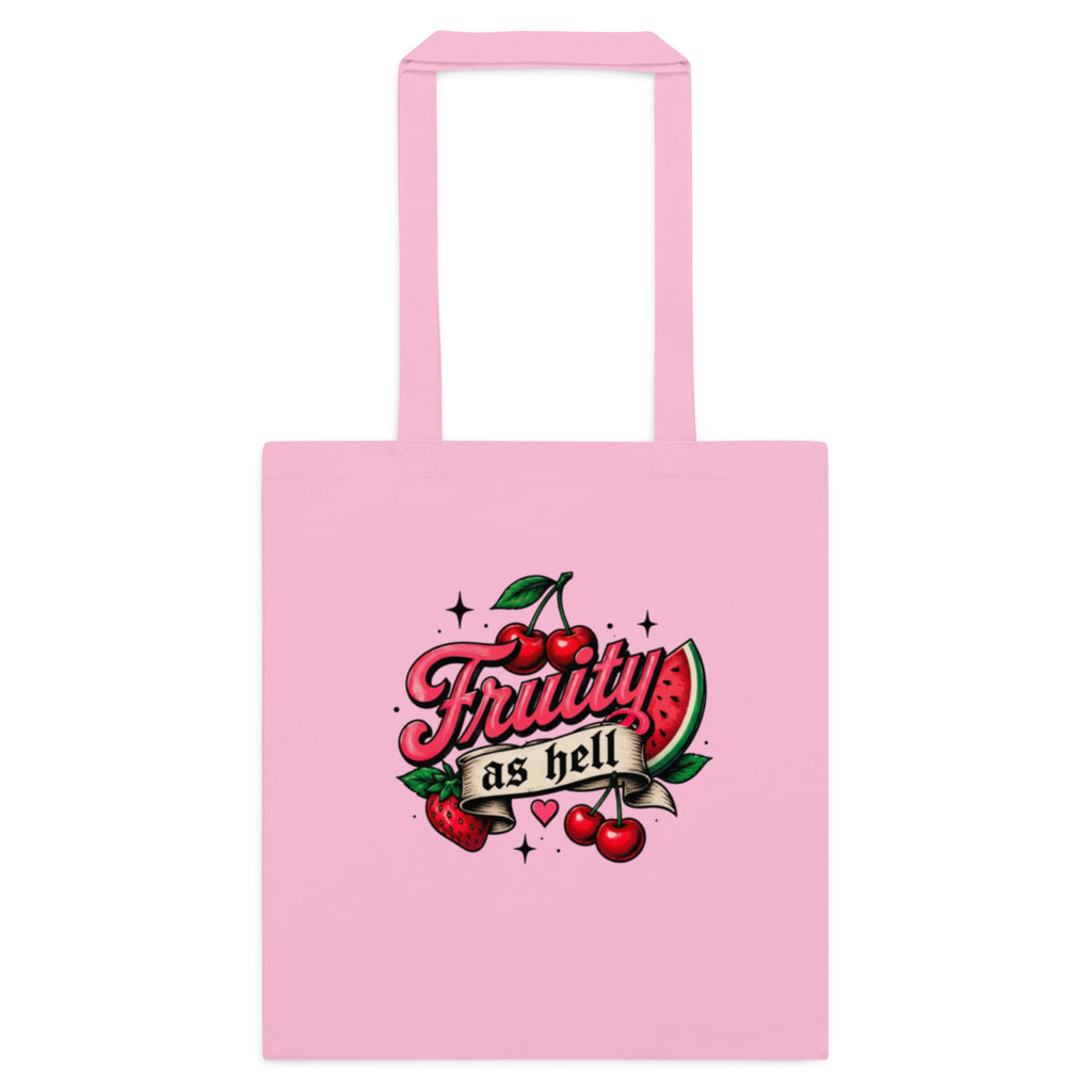 A light pink canvas tote bag with two top handles, featuring a retro-style graphic on the front that reads 'Fruity as hell' in red script, decorated with cherries, a watermelon slice, and small stars.