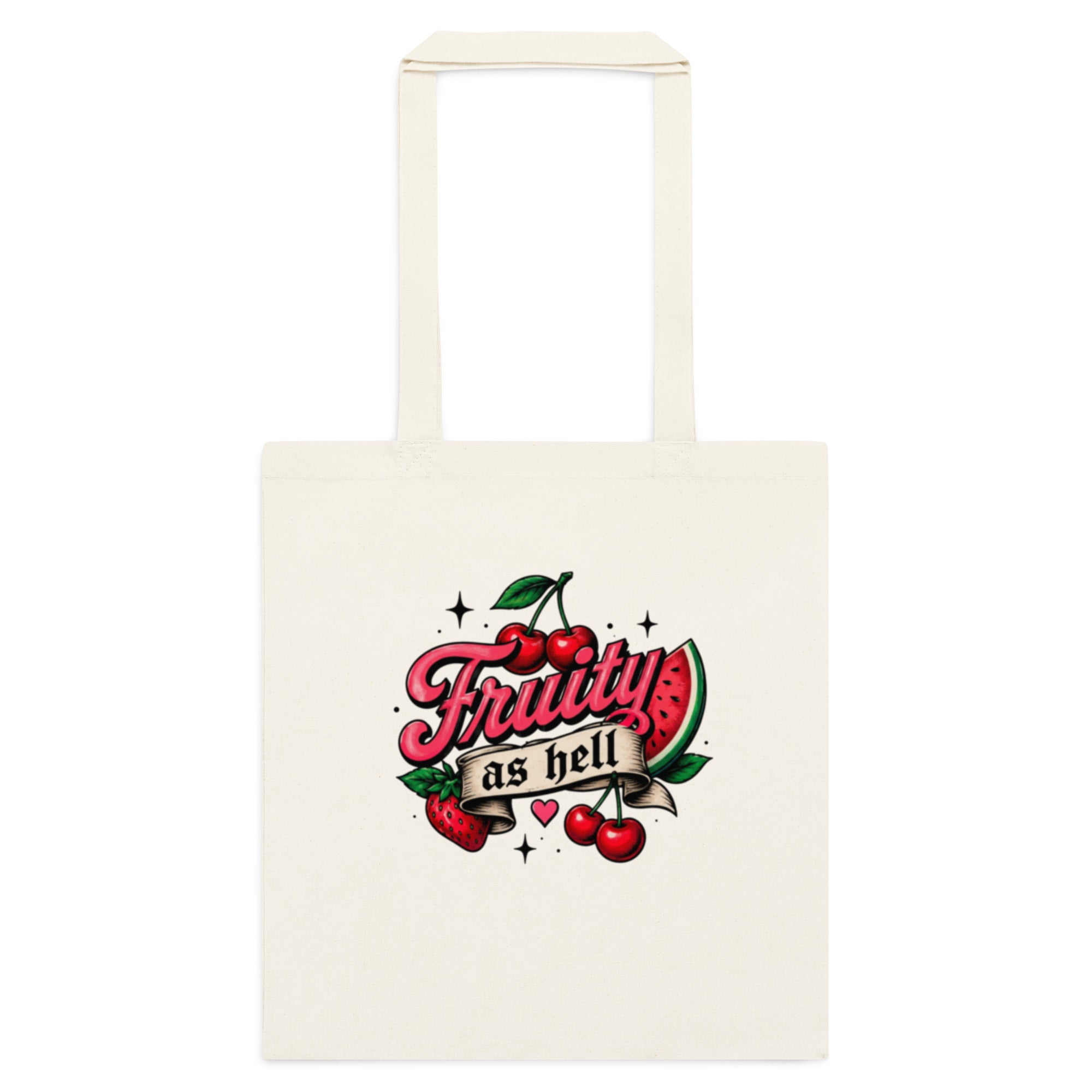 An off-white canvas tote bag with a retro-style graphic on the front featuring the text 'Fruity as hell' in pink script over red cherries and a watermelon slice.