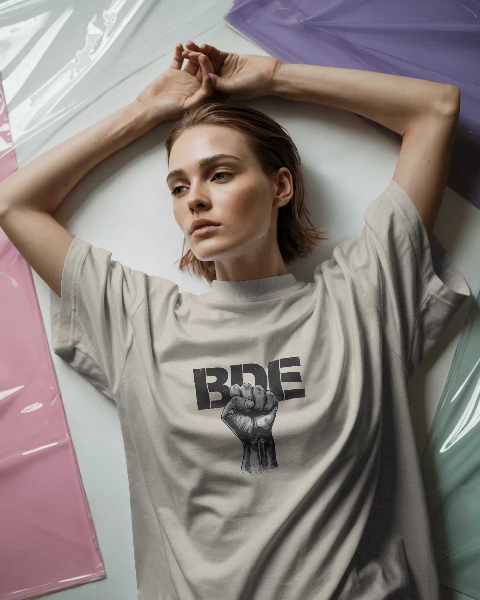 Masc lesbian wearing oversized BDE queer slogan t shirt