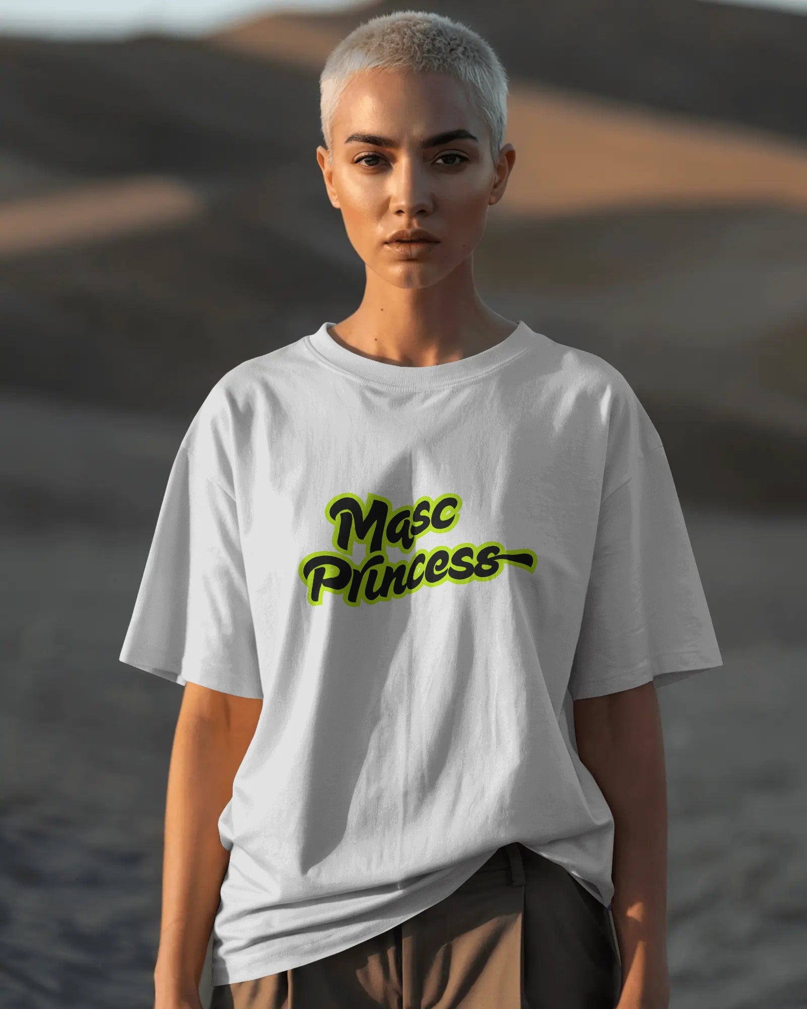 Female model wearing black Masc Princess oversized t-shirt with neon green slogan, styled with ripped jeans and sunglasses, queer streetwear fashion