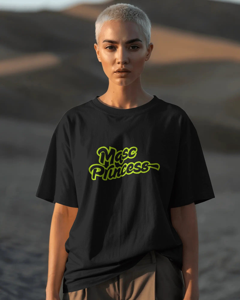 Female model wearing black Masc Princess oversized t-shirt with neon green slogan, styled with ripped jeans and sunglasses, queer streetwear fashion