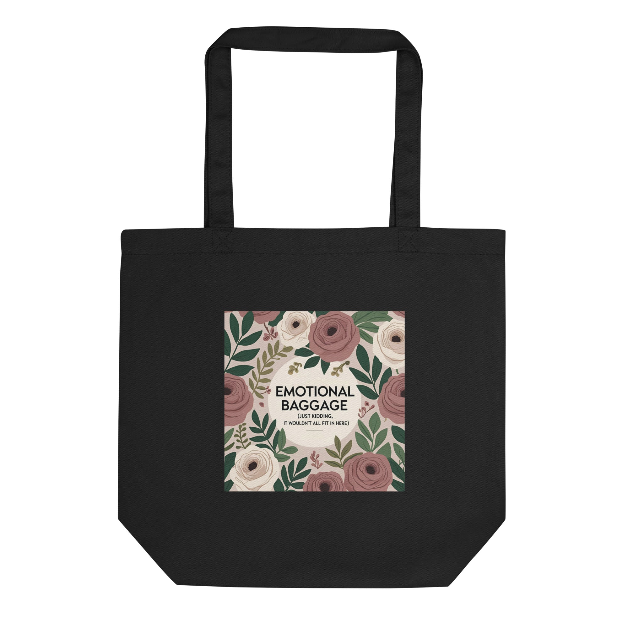 Black canvas tote bag with black text that reads “Emotional baggage… just kidding, it wouldn’t fit here” – laid flat on a wooden surface