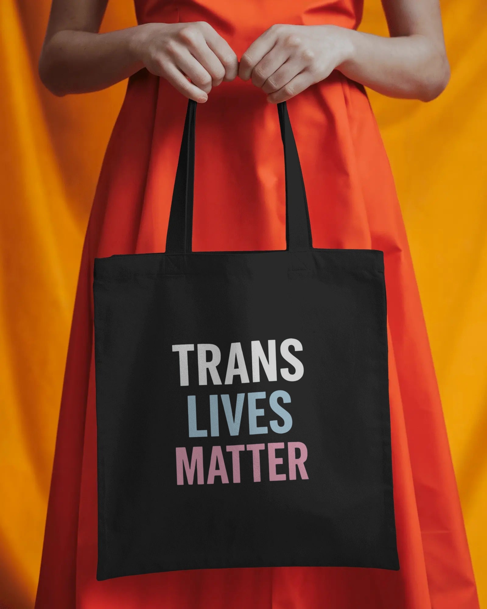 Organic cotton tote bag with “Trans Lives Matter” slogan, queer-owned eco tote by Savage Cotton