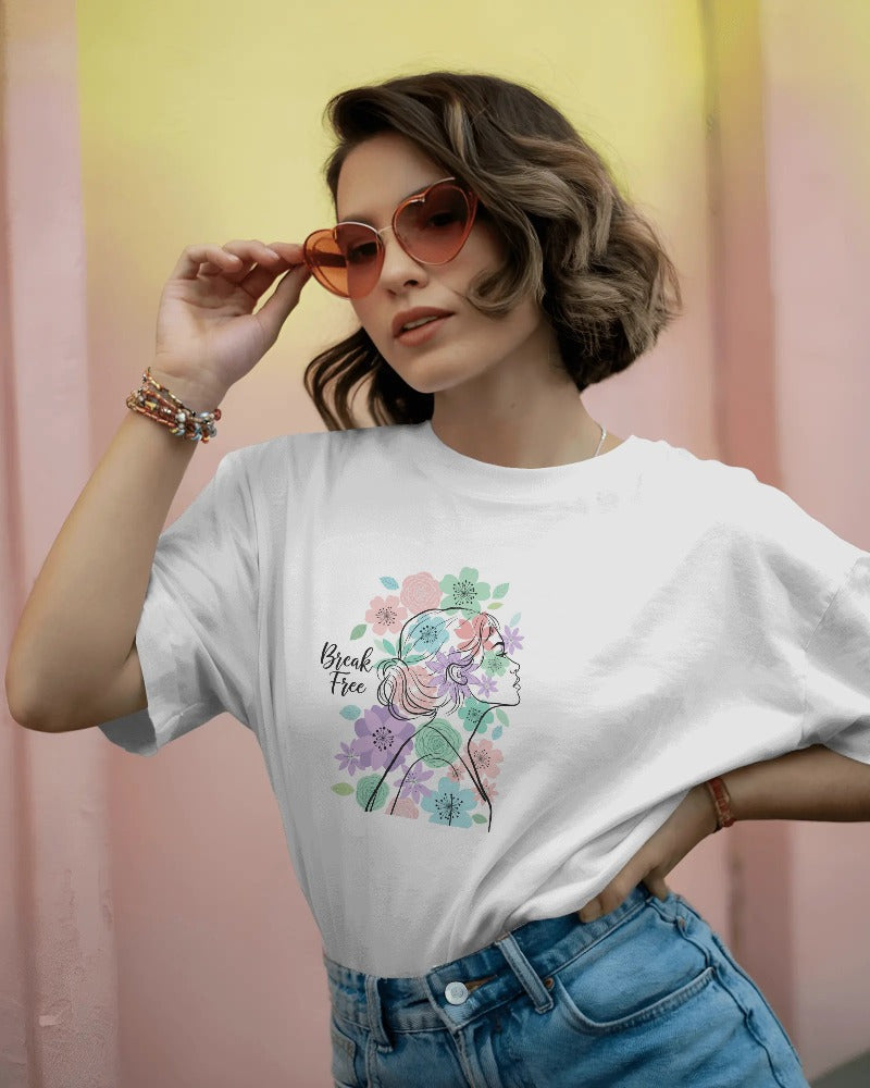 Woman wearing a white t-shirt with floral design and text, holding sunglasses against a pastel gradient background.