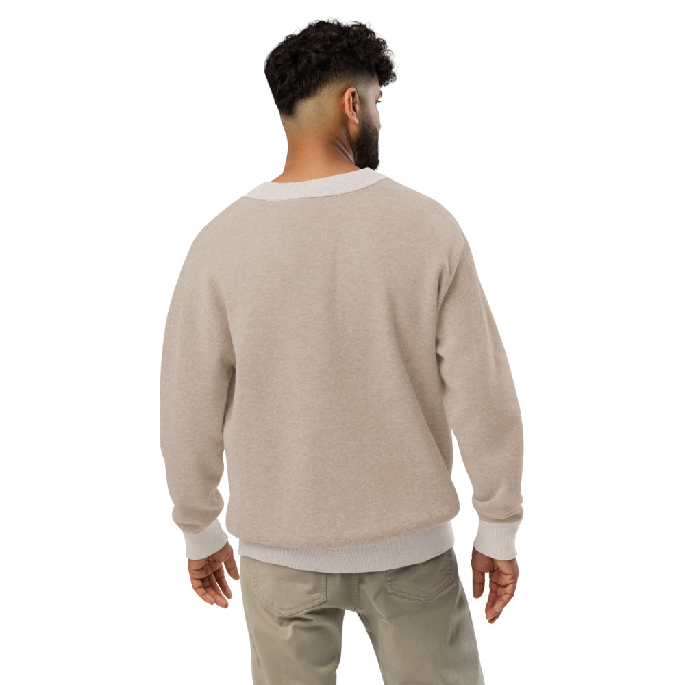 Man wearing a beige sweater and pants on a white background