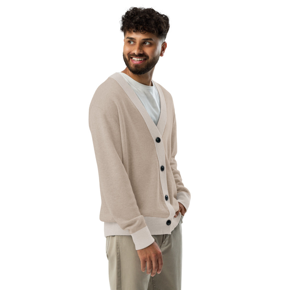 Man wearing a beige cardigan with black buttons on a white background