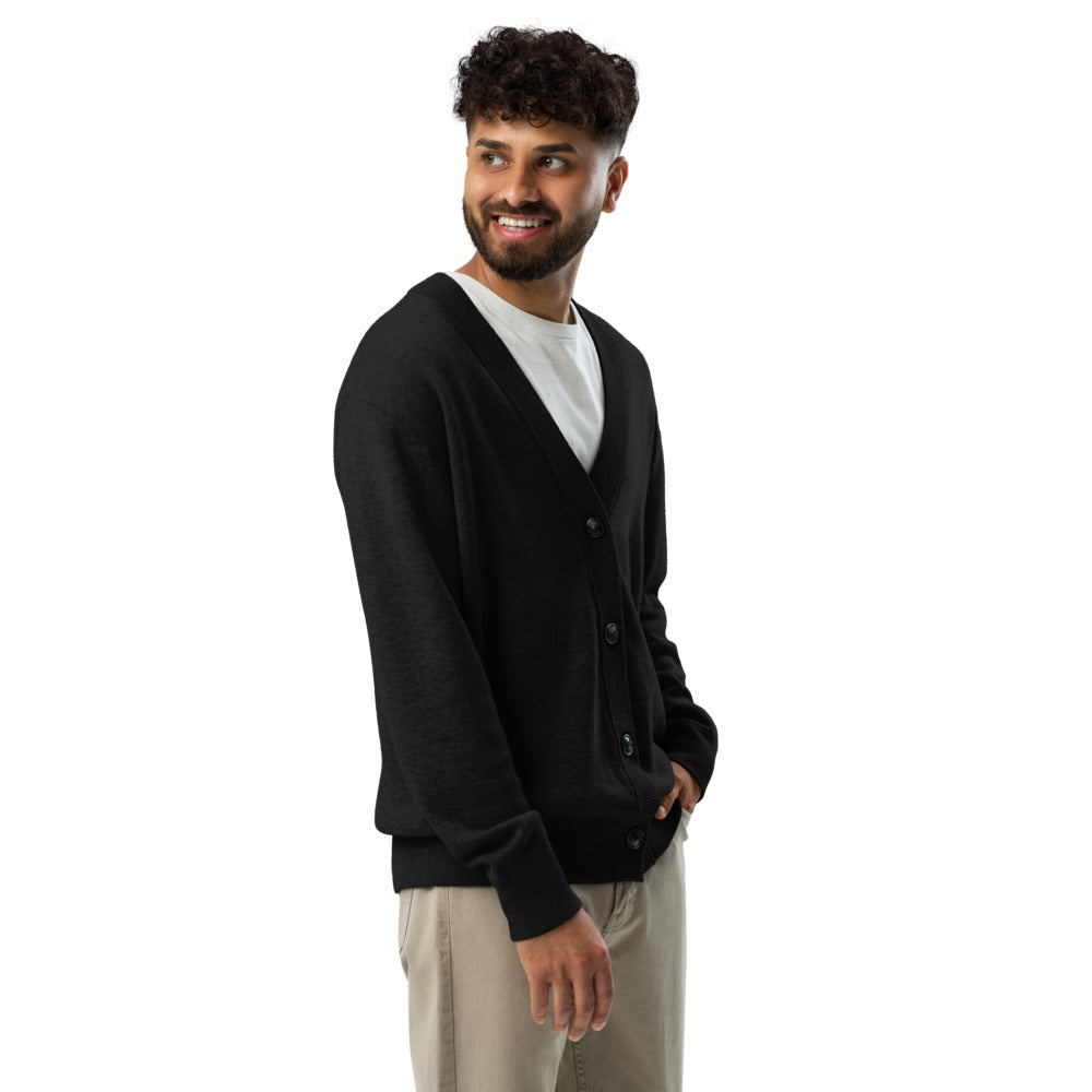 Man wearing a black cardigan over a white shirt on a white background
