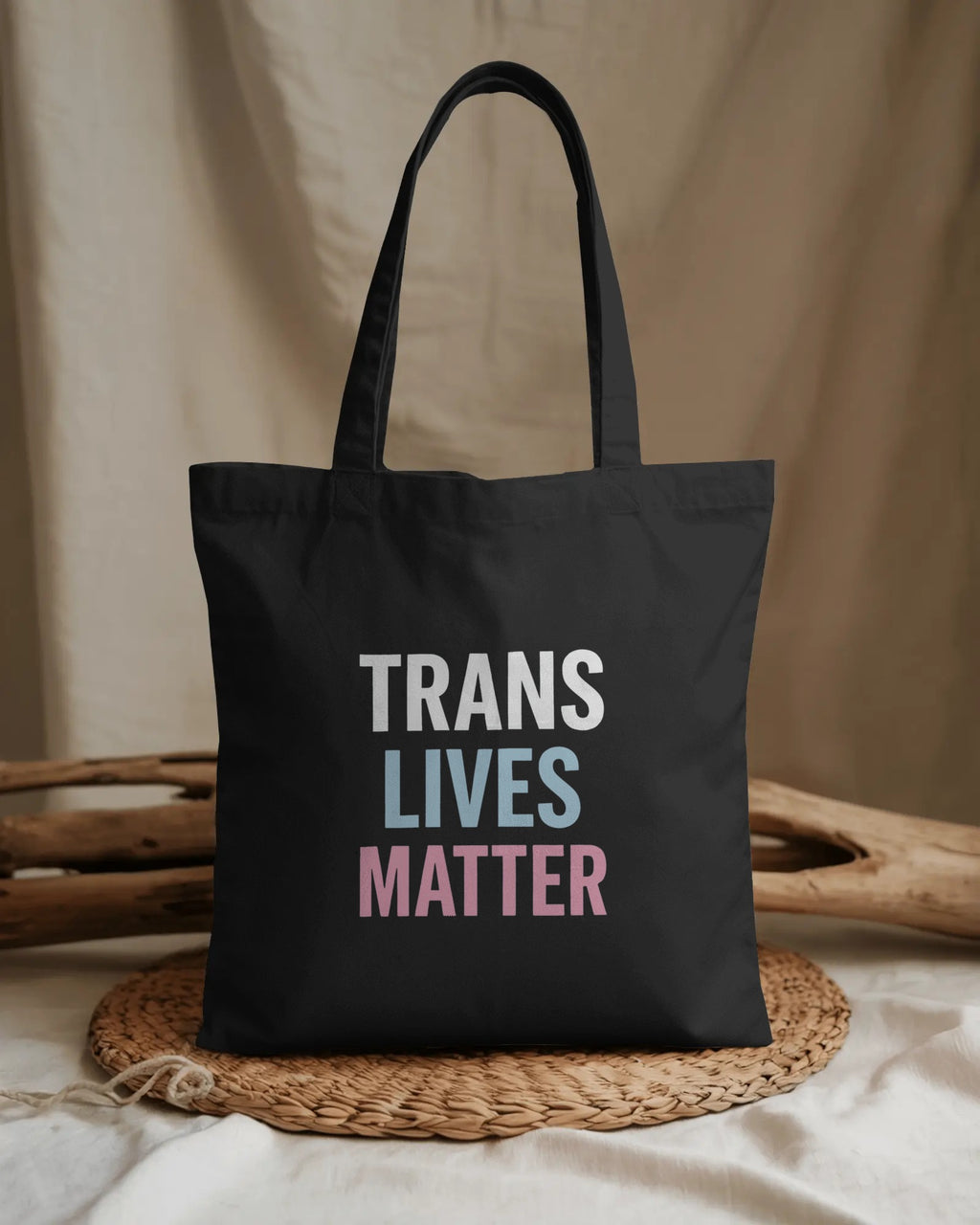 Organic cotton tote bag with “Trans Lives Matter” slogan, queer-owned eco tote by Savage Cotton
