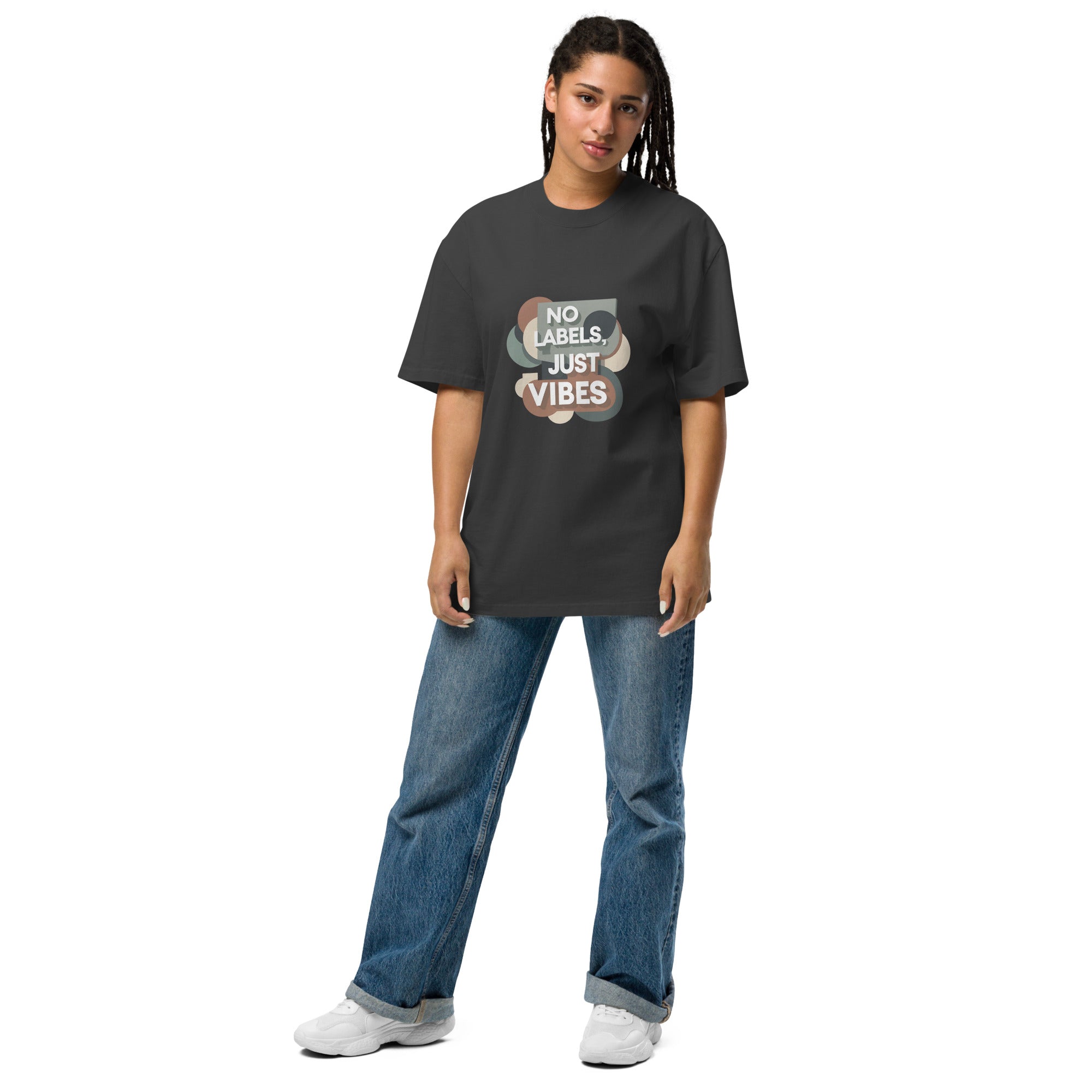 Person wearing a dark gray t-shirt with 'No Labels Just Vibes' text and graphic, standing against a white background.