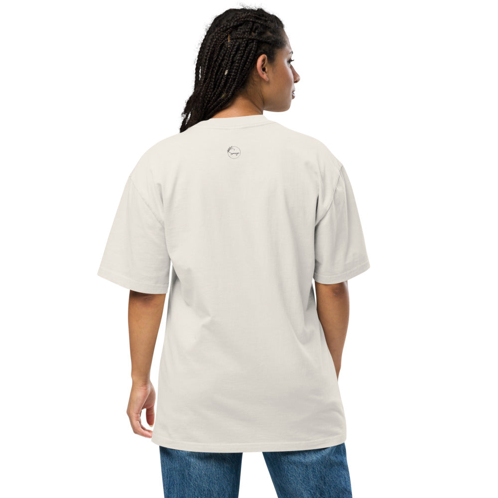 Person wearing a beige t-shirt with a logo on the back, standing against a white background
