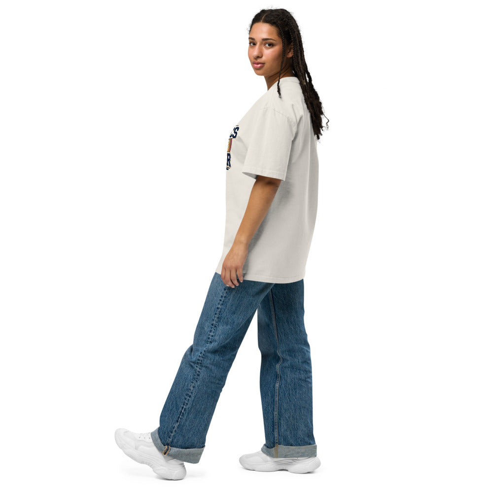 Person wearing a beige oversized t-shirt and blue jeans on a white background