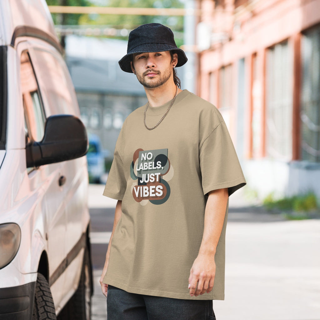 Man wearing a beige t-shirt with 'No Labels, Just Vibes' text standing next to a van.
