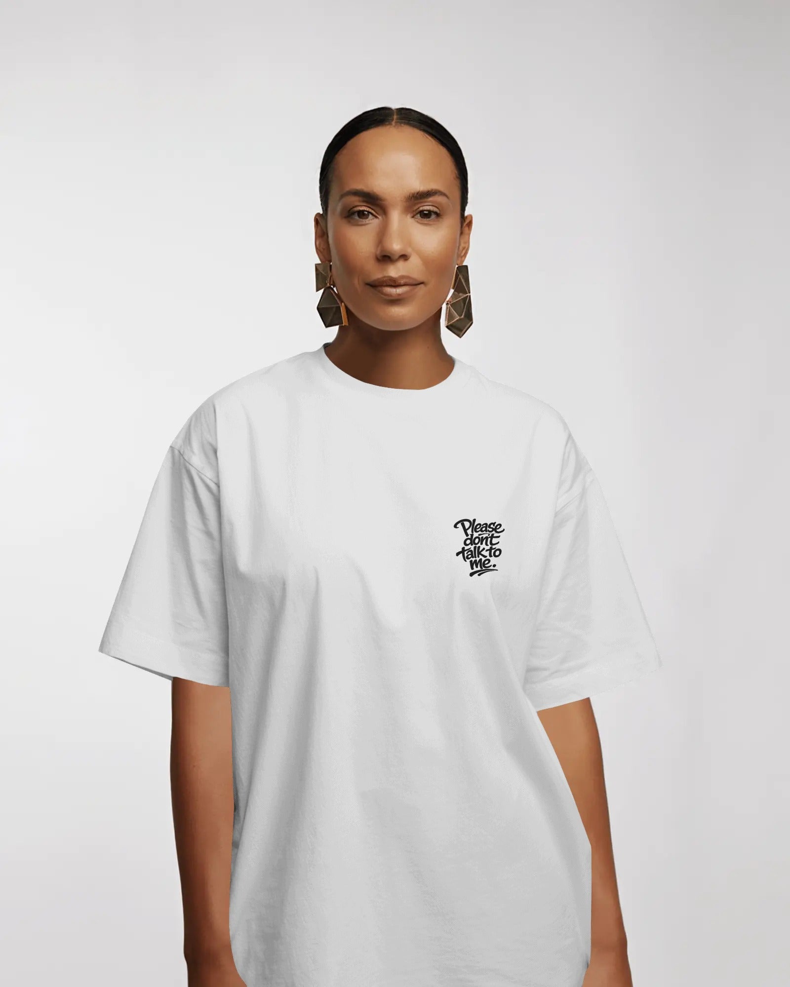 Model wearing a black oversized “Please Don’t Talk To Me” slogan t-shirt with relaxed fit and dropped shoulders, styled for everyday streetwear.