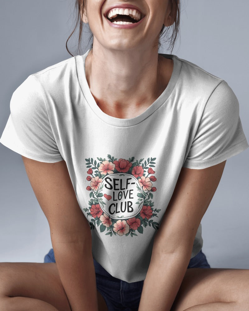 Person wearing a white t-shirt with 'Self-Love Club' design on a gray background
