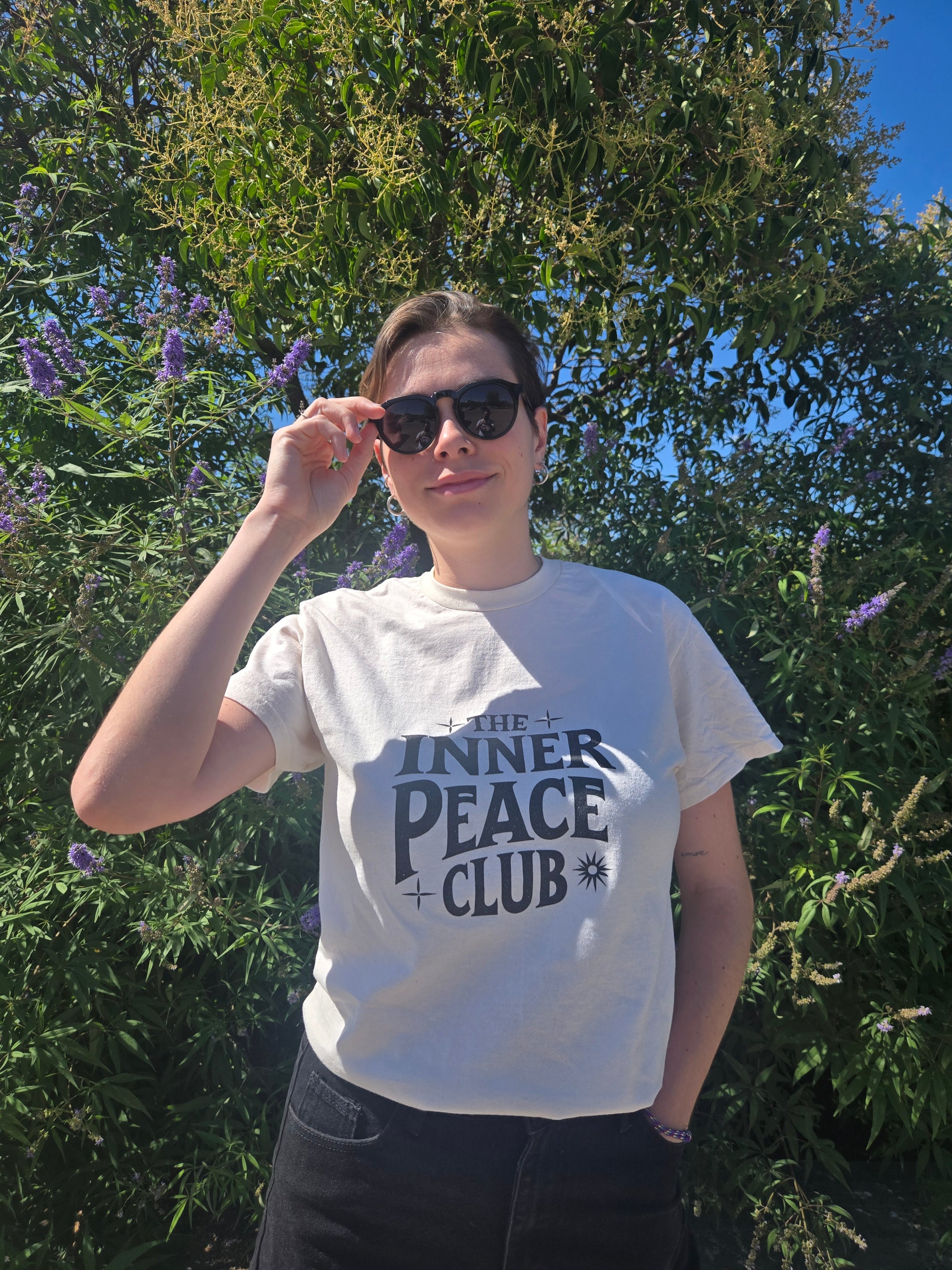 Model posing in front of plant