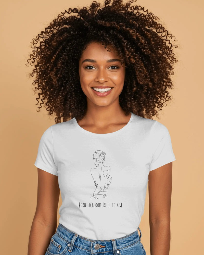 Model wearing oversized "Born to Bloom, Built to Rise" graphic tee – bold black lettering on soft cotton, streetwear with a message