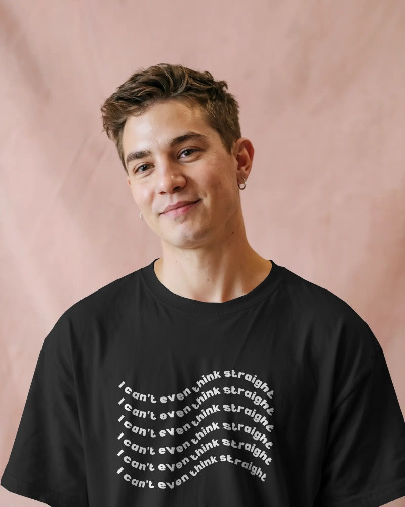 Person wearing a black t-shirt with text on a pink background