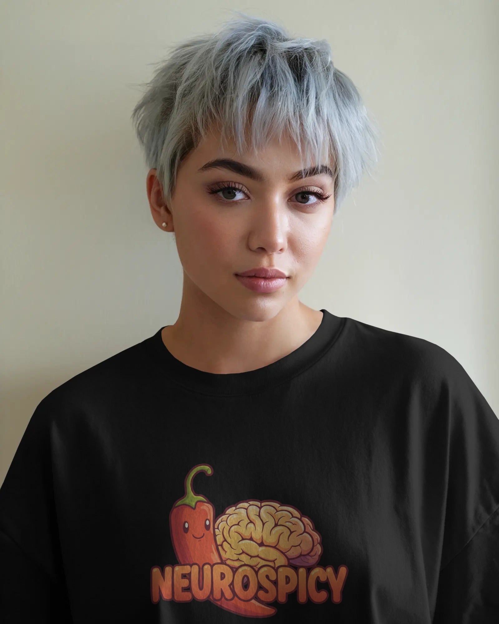 Neurospicy slogan t-shirt worn by a confident model, celebrating neurodivergence and mental health with bold, playful typography