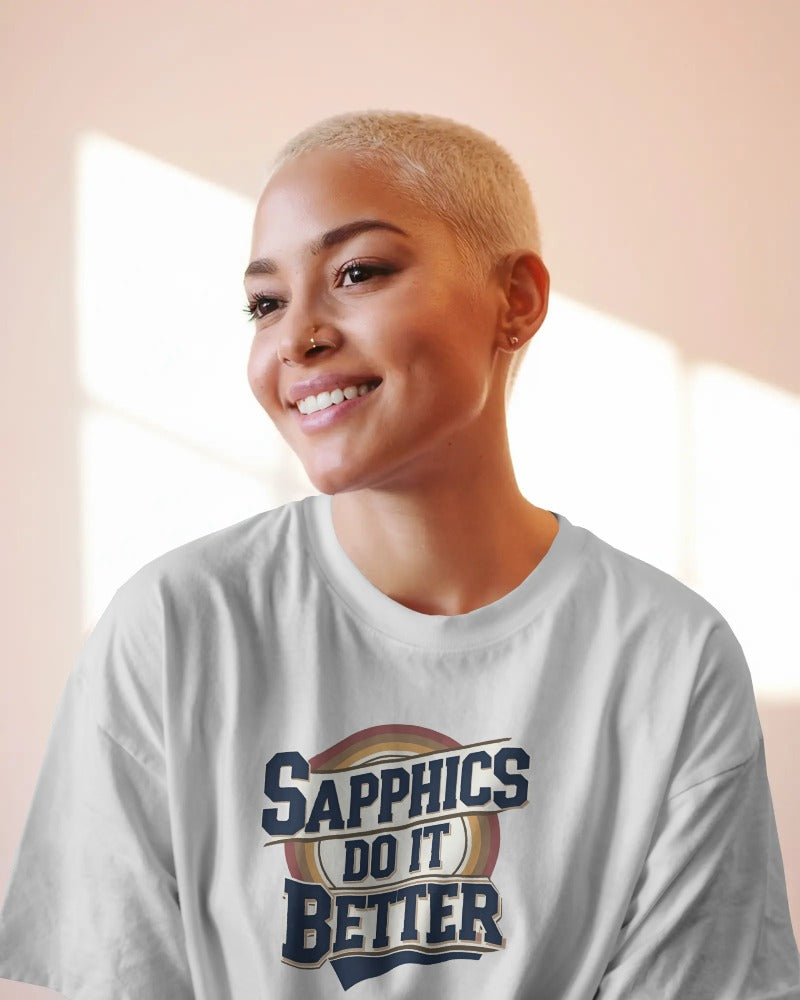 Model wearing oversized Shappics Do It Better slogan T-shirt by Savage Cotton in black with bold white print, styled with boots and attitude
