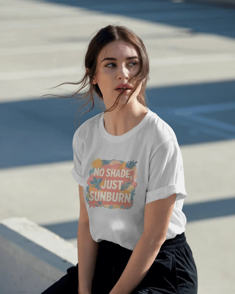 Model wearing No Shade, Just Sunburn slogan T-shirt by Savage Cotton in sunshine yellow, styled with sunglasses and a Pride flag