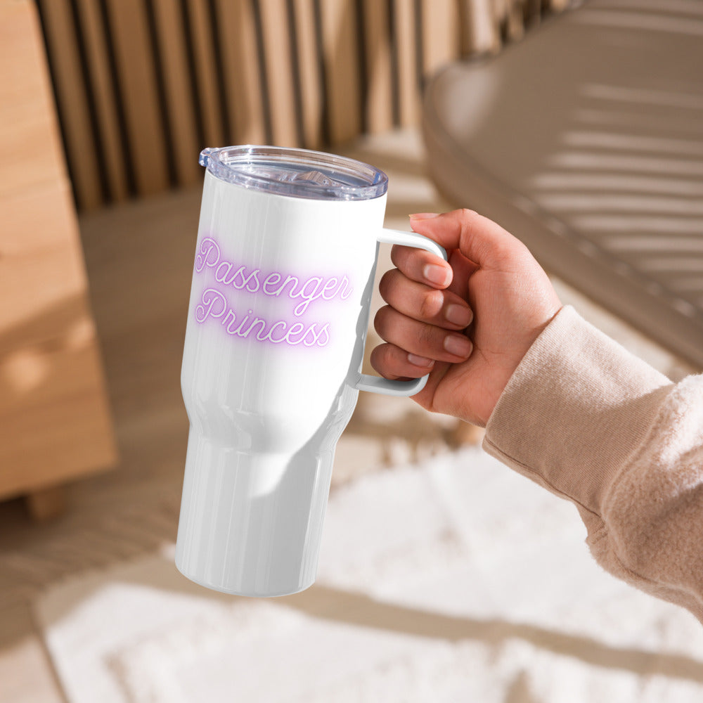 White tumbler with 'Passenger Princess' text held by a hand in a casual setting.