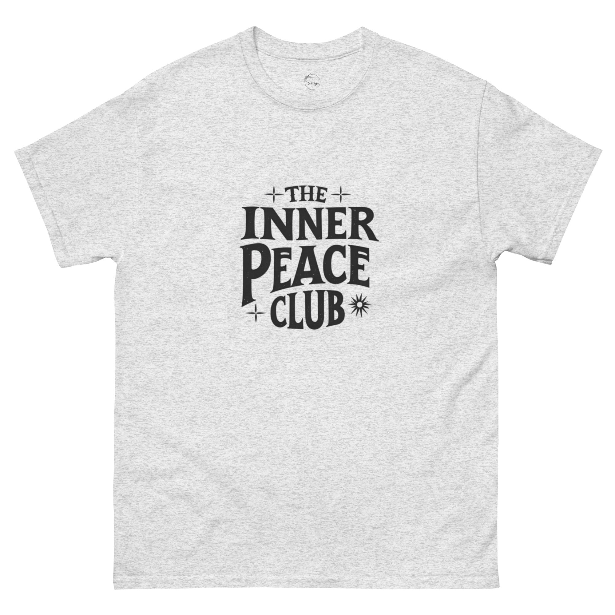 Flat lay of a cream-colored “The Inner Peace Club” t-shirt with soft lettering, styled with pastel accessories and cozy neutral tones.