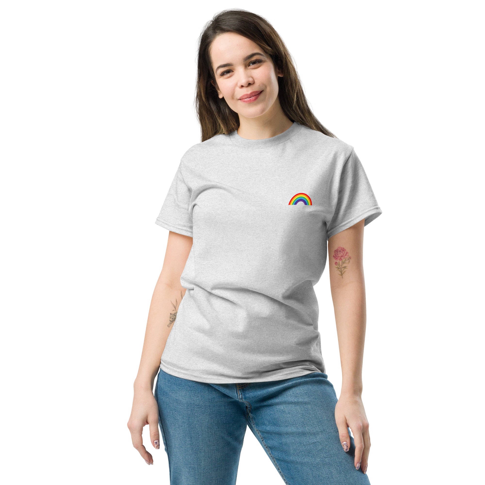 Woman wearing a gray t-shirt with a rainbow design on a white background