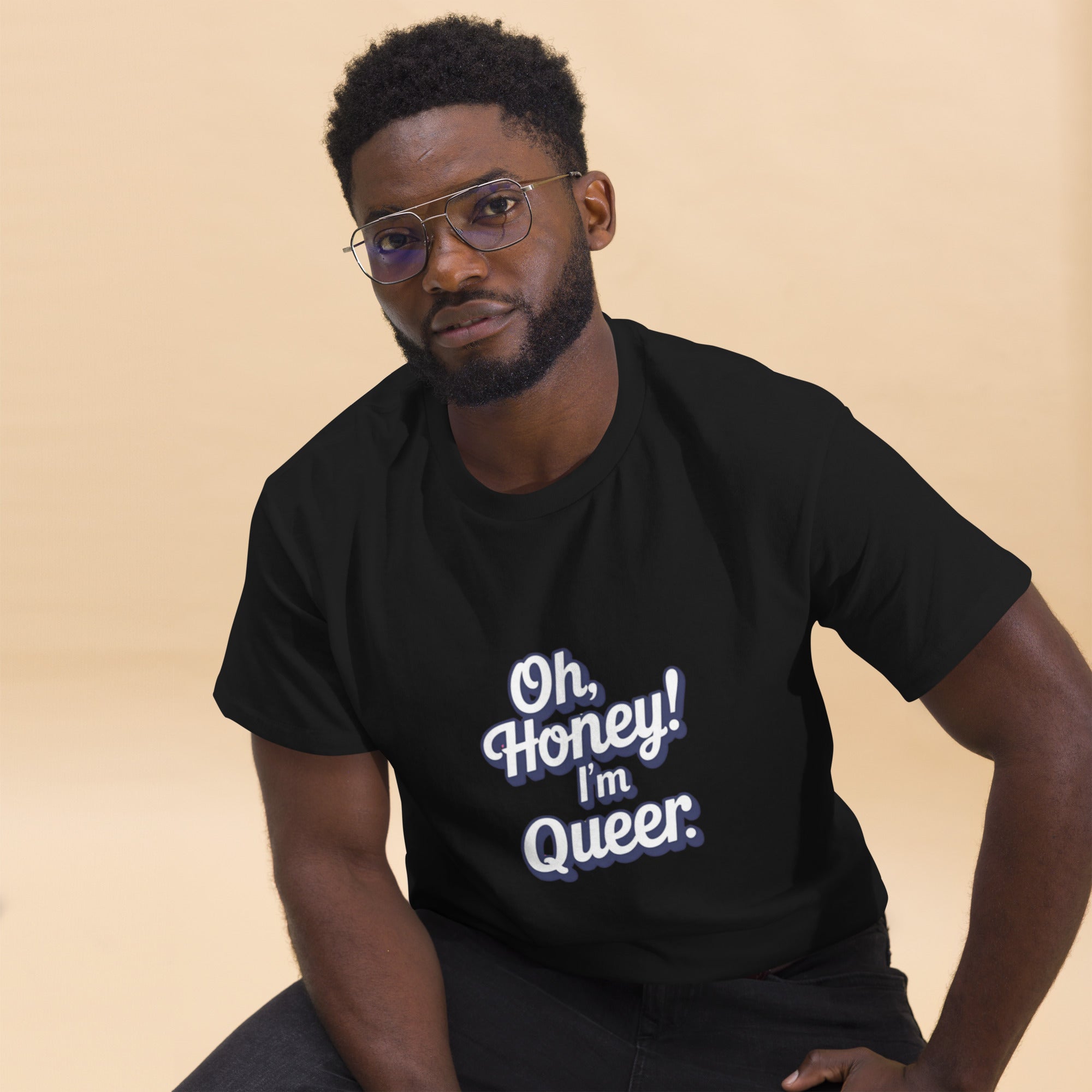 Man wearing a black t-shirt with 'Oh, Honey! I'm Queer.' text on a beige background