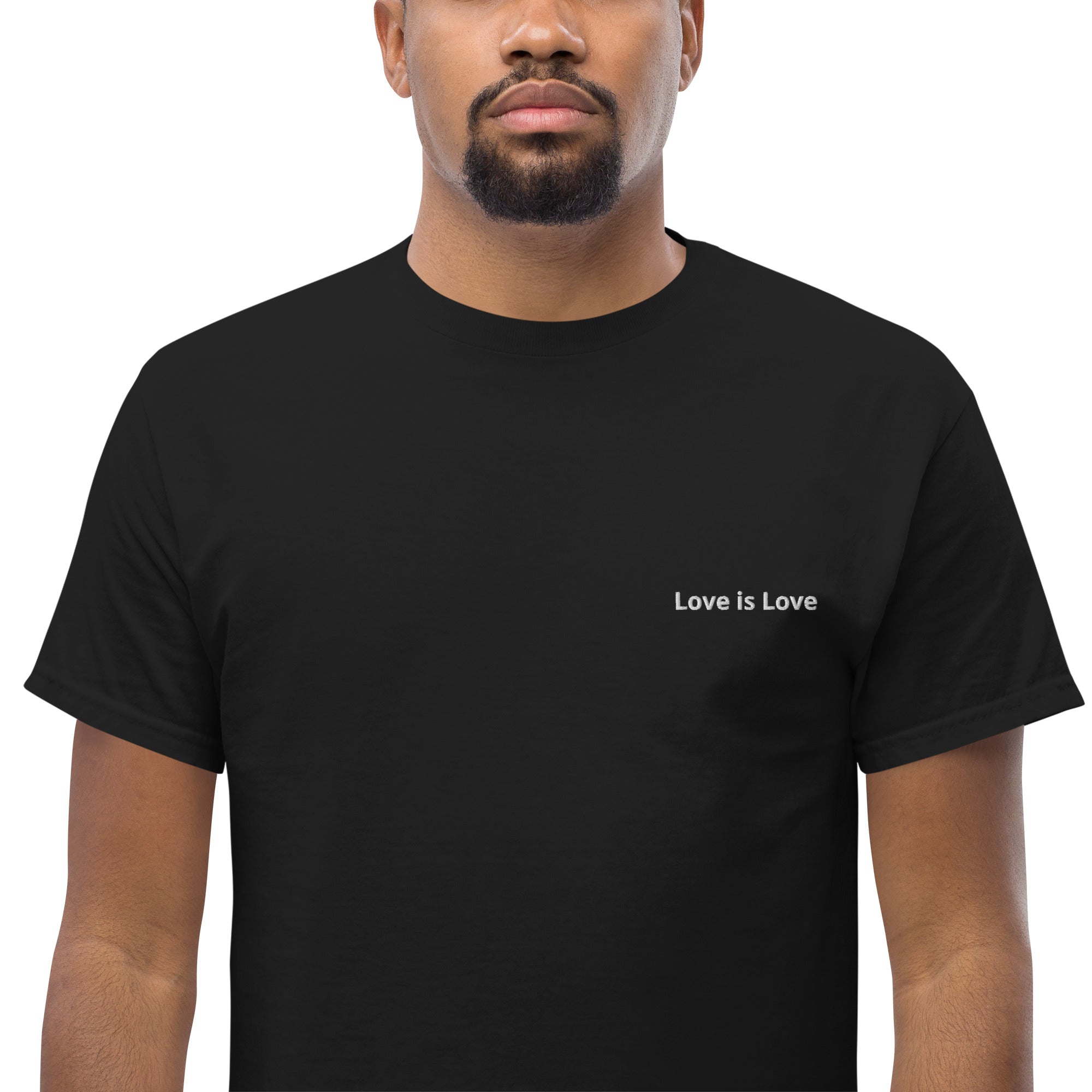 Person wearing a black t-shirt with 'Love is Love' text on a white background