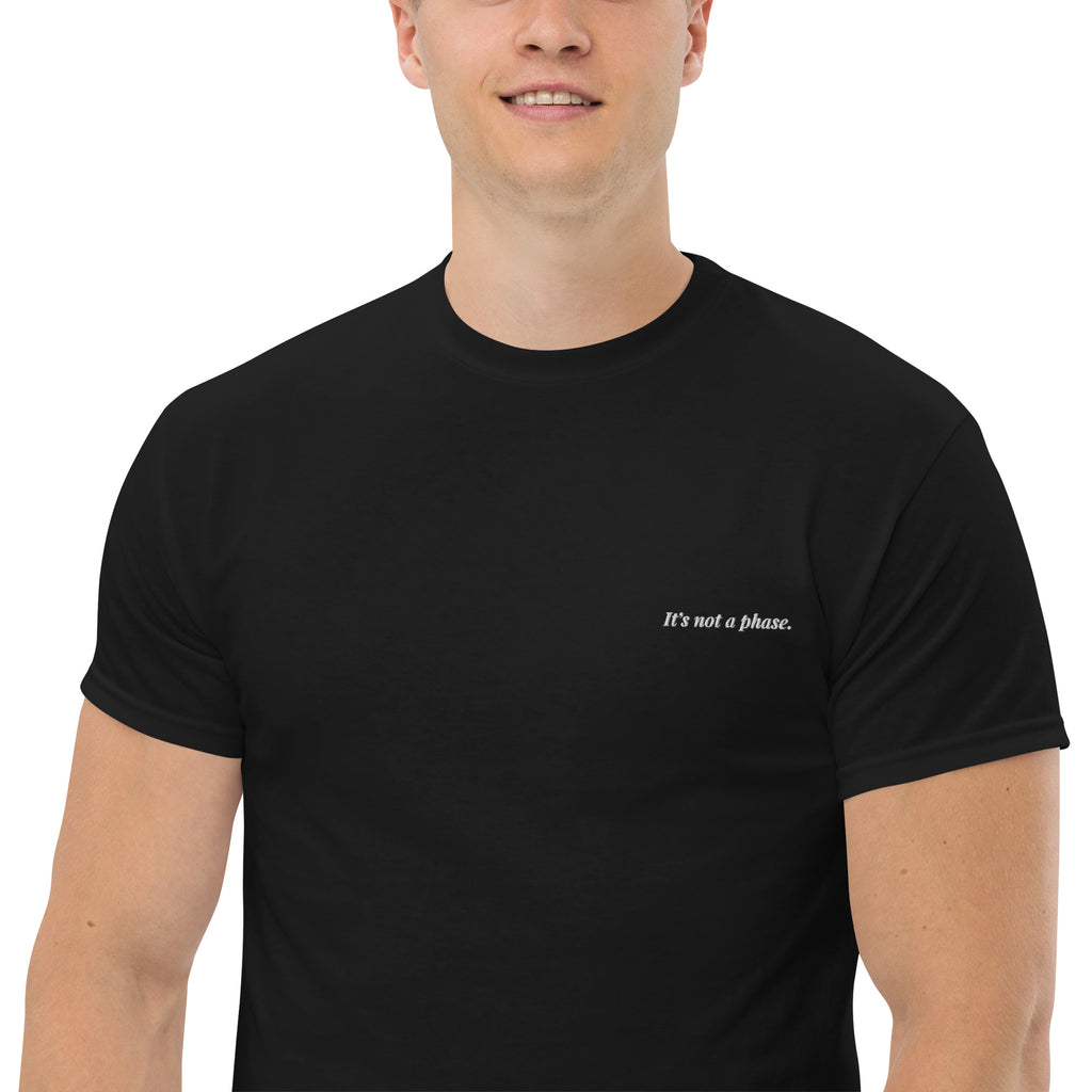 Man wearing a black t-shirt with text on a white background