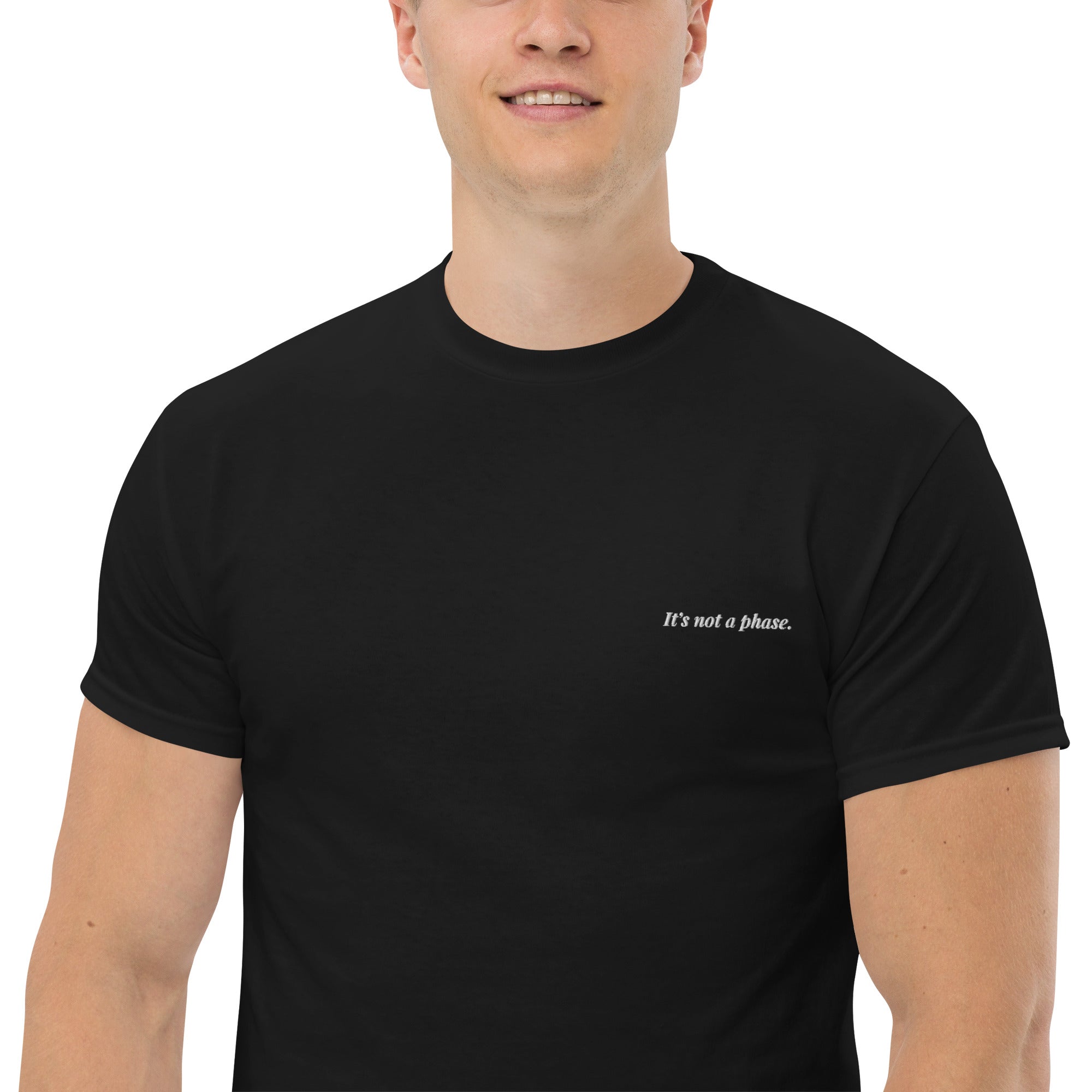 Man wearing a black t-shirt with text on a white background