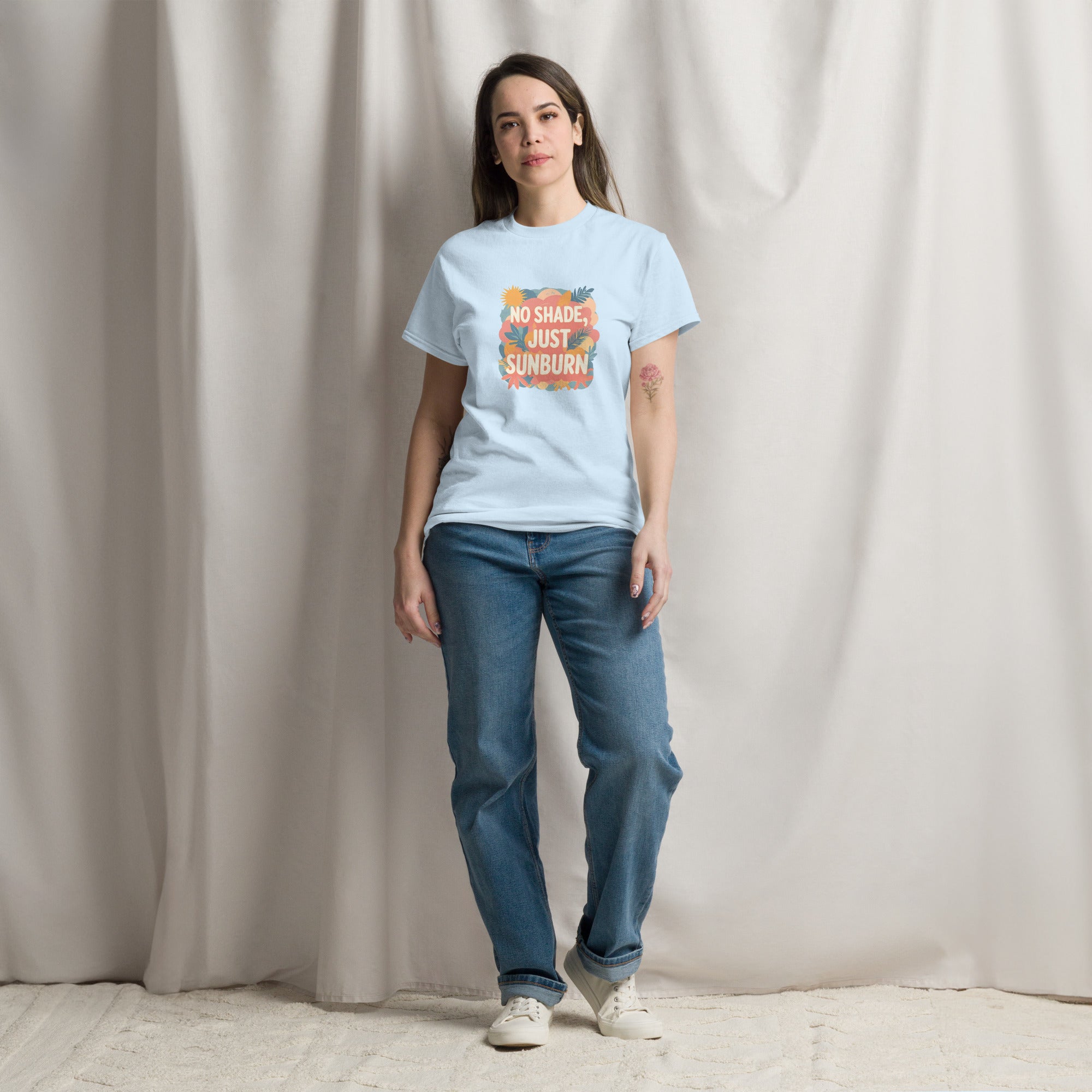 Model wearing No Shade, Just Sunburn slogan T-shirt by Savage Cotton in sunshine yellow, styled with sunglasses and a Pride flag